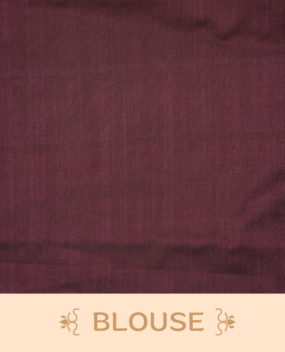Burgundy soft silk saree features a sleek borderless design with intricate antique zari motifs, flowing into a seamless self colored pallu and a matching blouse piece.