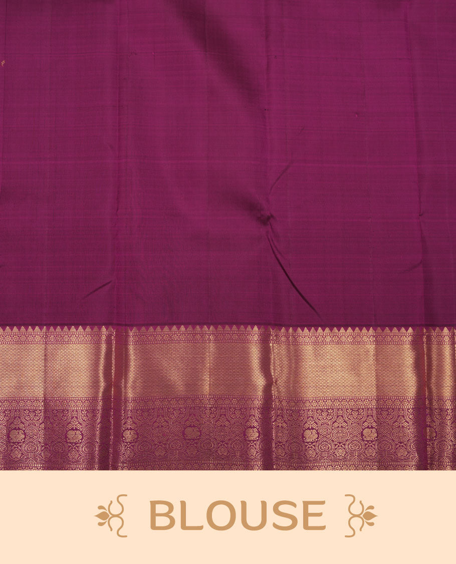 Rich magenta colour pure traditional Kancheepuram silk saree adorned with an elegant zari motif on the body, complemented by a grand gold zari woven border with intricate traditional patterns, paired with a matching blouse piece.