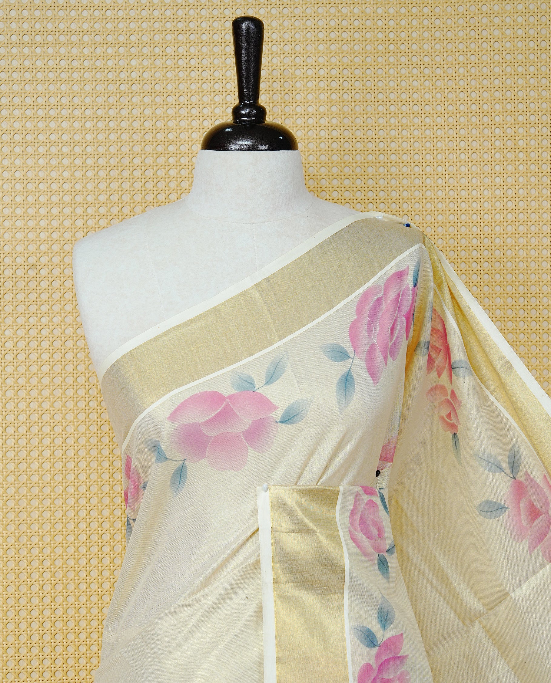Cream Colour Tissue Kerala Saree Featuring Digital Pink Rose Prints Across The Body, Enhanced With A Gold Zari Border , Finished With Pink & Cream Tassels And A Matching Blouse Piece