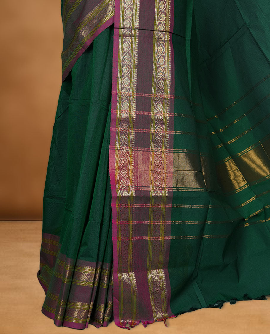 Dark green colour chettinad cotton saree featuring Elegant plain body, contrast Dusty Magenta colour border with gold zari border, pallu and paired with matching blouse.