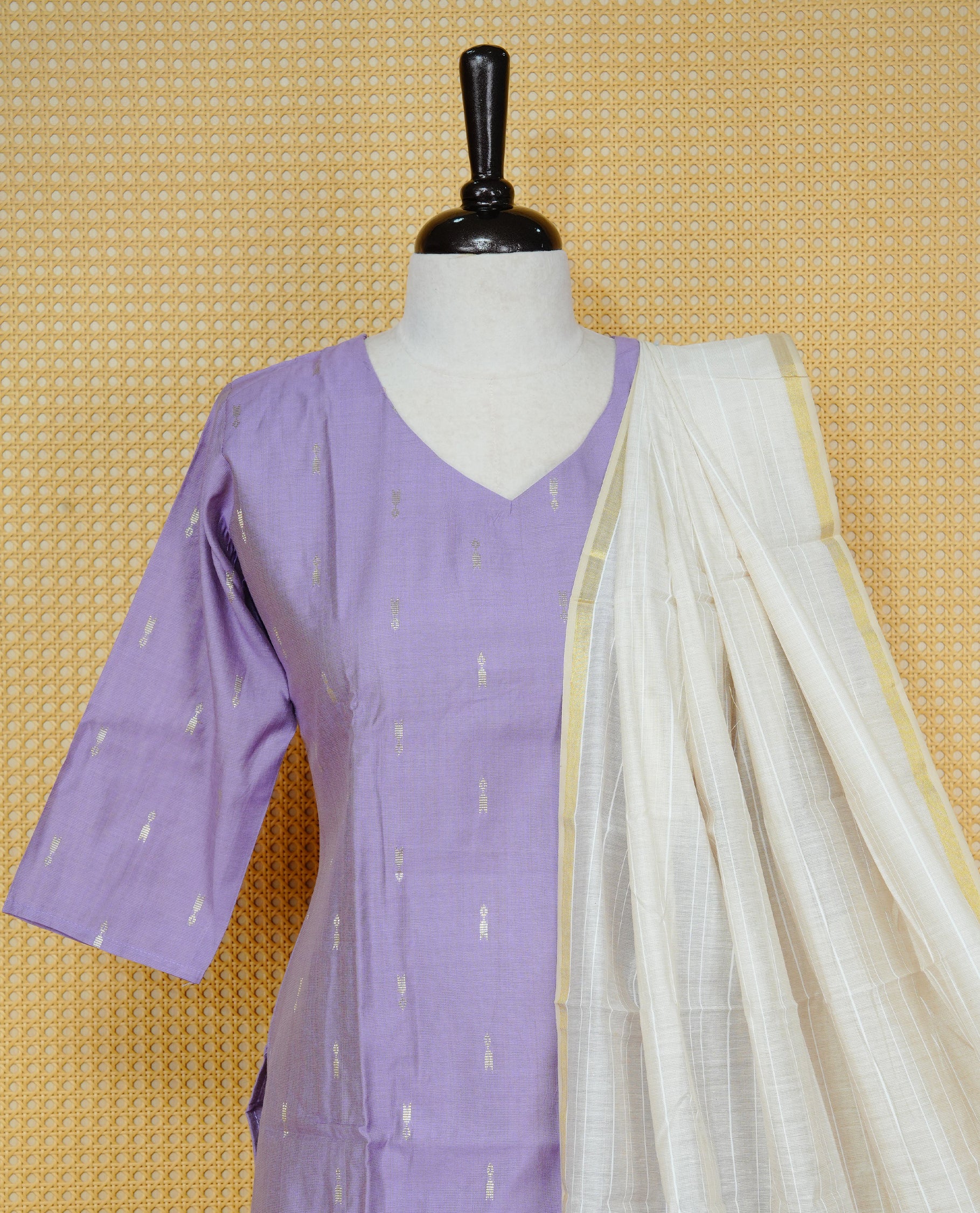 Lavender colour churidar set featuring subtle woven motifs on the kurta, paired with matching solid pants and an off-white dupatta .