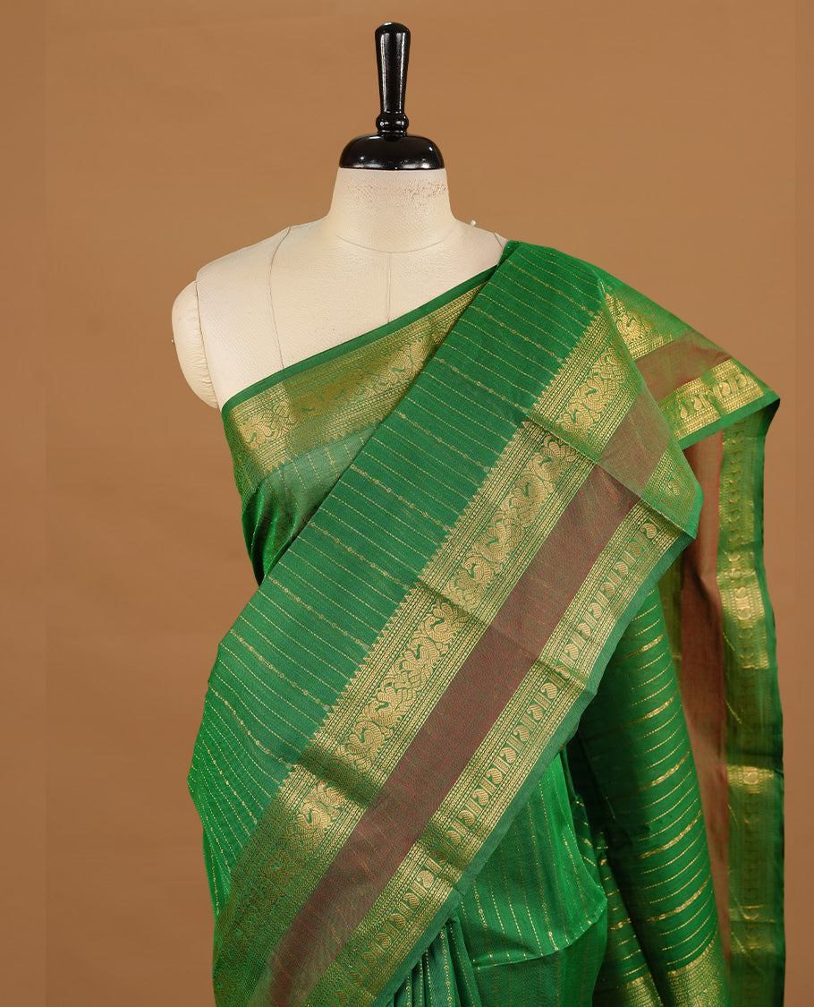 Green colour chettinad cotton saree featuring gold zari stripes on body, highlighting Mixed red colour with zari border, paired with matching blouse piece.