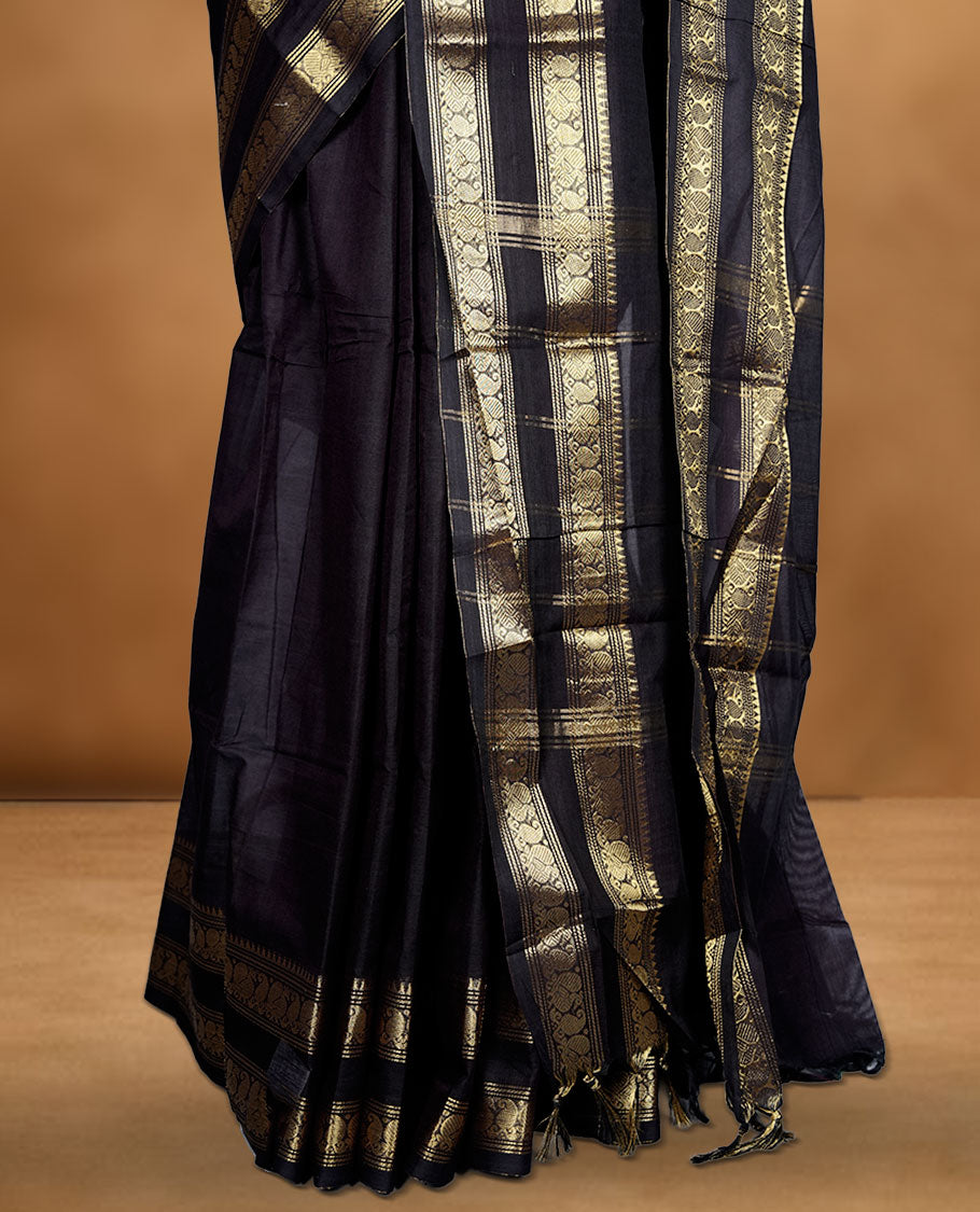 Dark Navy Blue colour chettinad cotton saree featuring plain body, with matching traditional gold zari border paired with matching blouse.