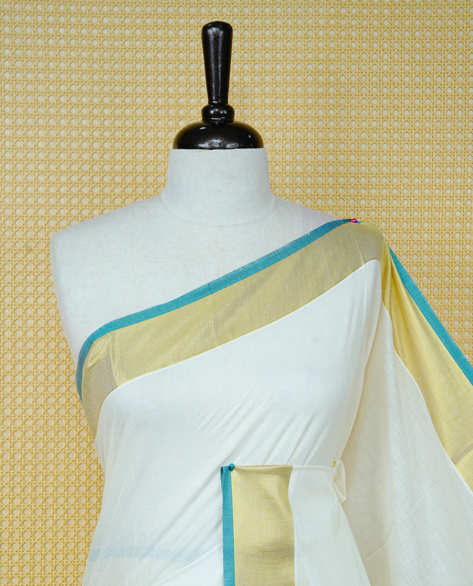 Cream colour Cotton kerala saree featuring Elegant Plain body, complemented by Gold zari with green colour border & Tassel on Pallu, paired with matching blouse piece.