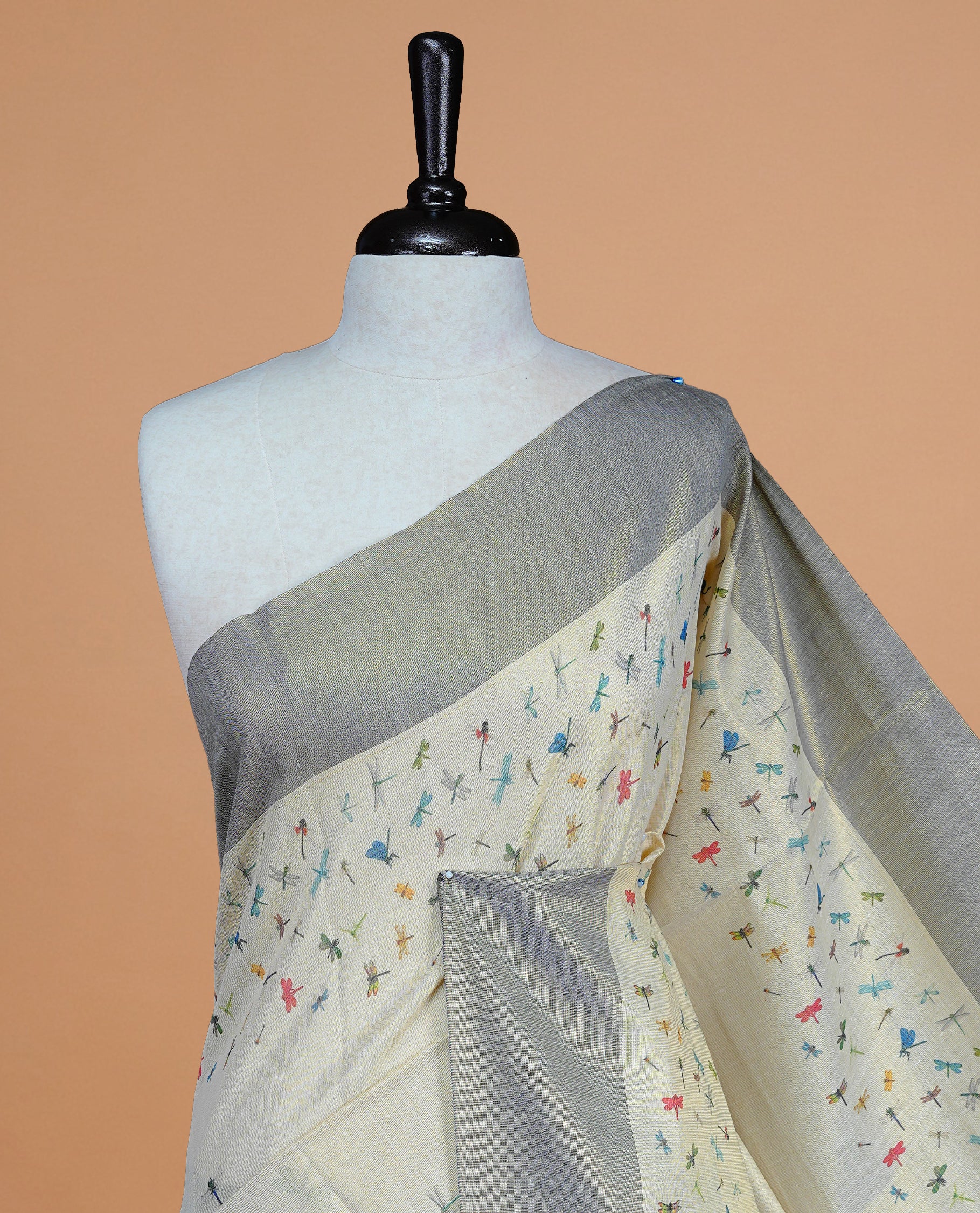Cream Colour Tissue Kerala Saree Featuring Plain Body ,Complemented By Blue Zari With Dragonfly Printed Border ,Enhance By A Blue With Gold Zari Pallu ,Paired With A Matching Blouse Piece.