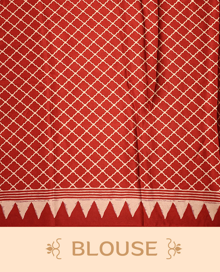 Maroon colour saree featuring bold striped patterns across the body, accentuated with a striking triangular border, and a contrasting pallu with geometric detailing, paired with a matching blouse