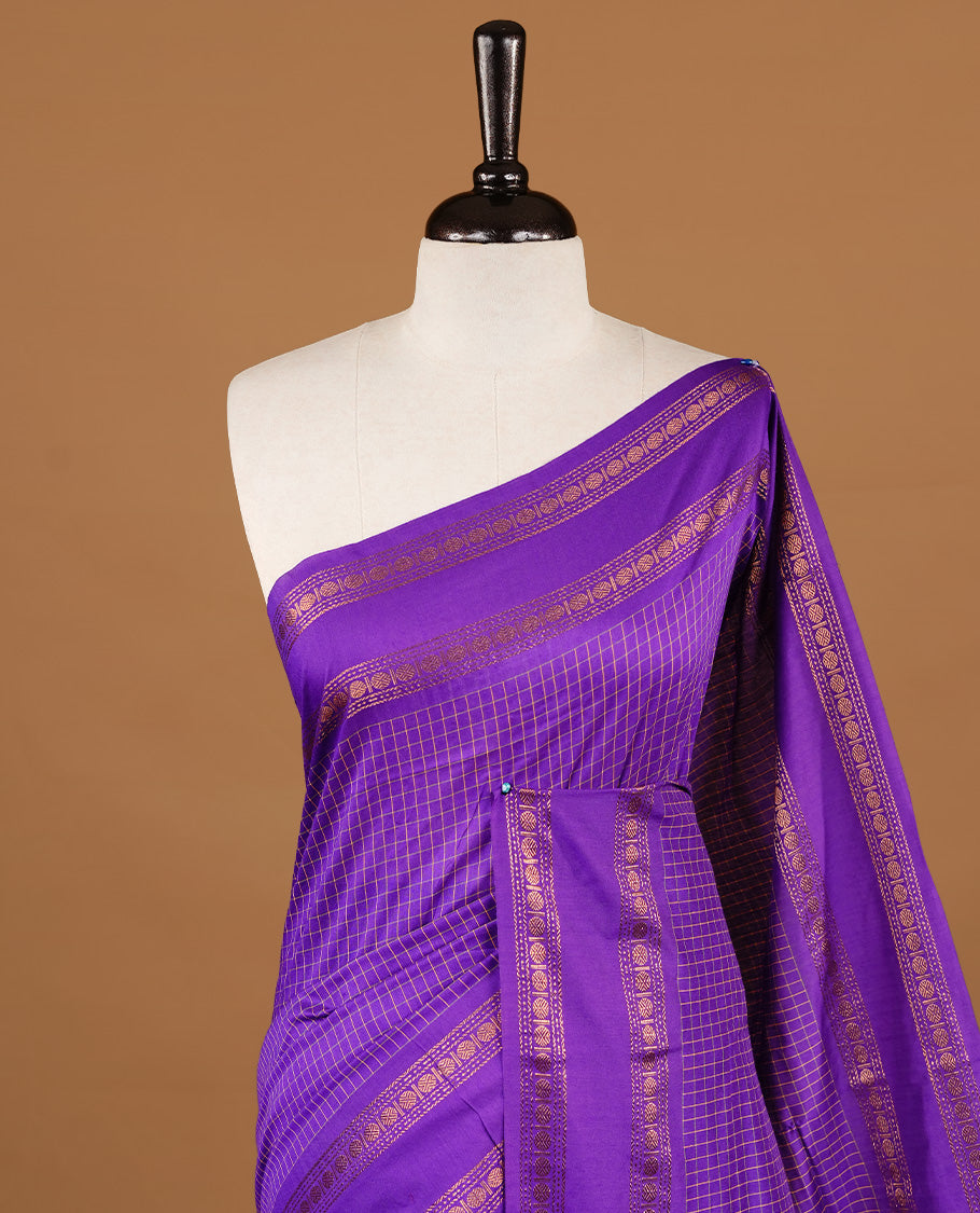 Indigo colour kalyani cotton saree featuring check pattern on body, highlighting self colour with simple gold zari border, paired with matching blouse piece.