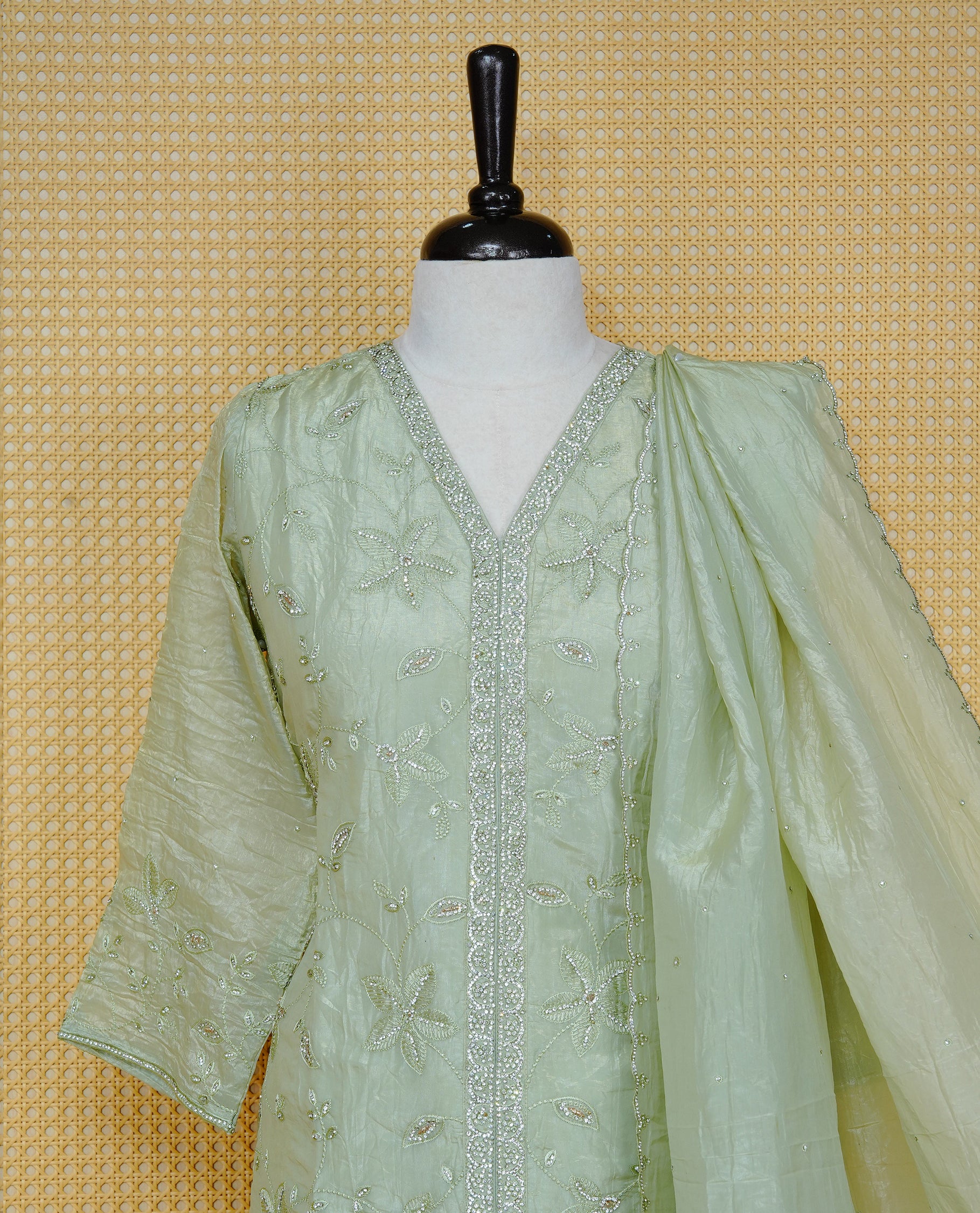 Pastel green colour churidar set with floral Stone & thread embroidery work on the V-neckline, paired with a matching embellished dupatta and solid pants.