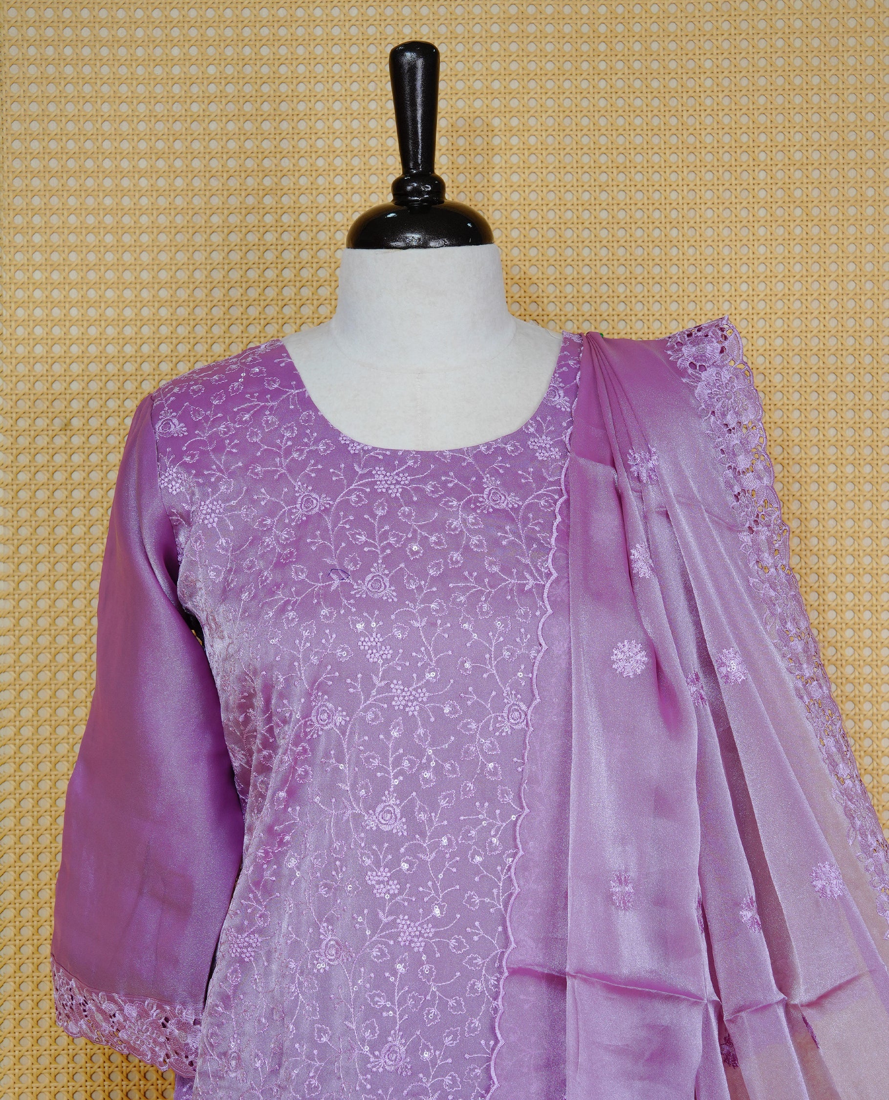 Lavender colour churidar set with floral thread embroidery on body & round neckline, paired with a matching embroidered dupatta and solid pants.