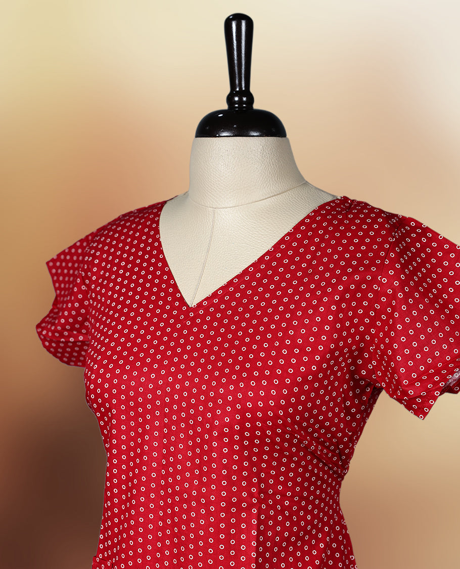 Red colour nightwear with tiny off white colour circles, V neckline, and flutter sleeves & The flared hem with pleats adds a chic touch, Ideal for casual wear, office looks, or relaxed outings with a stylish twist.