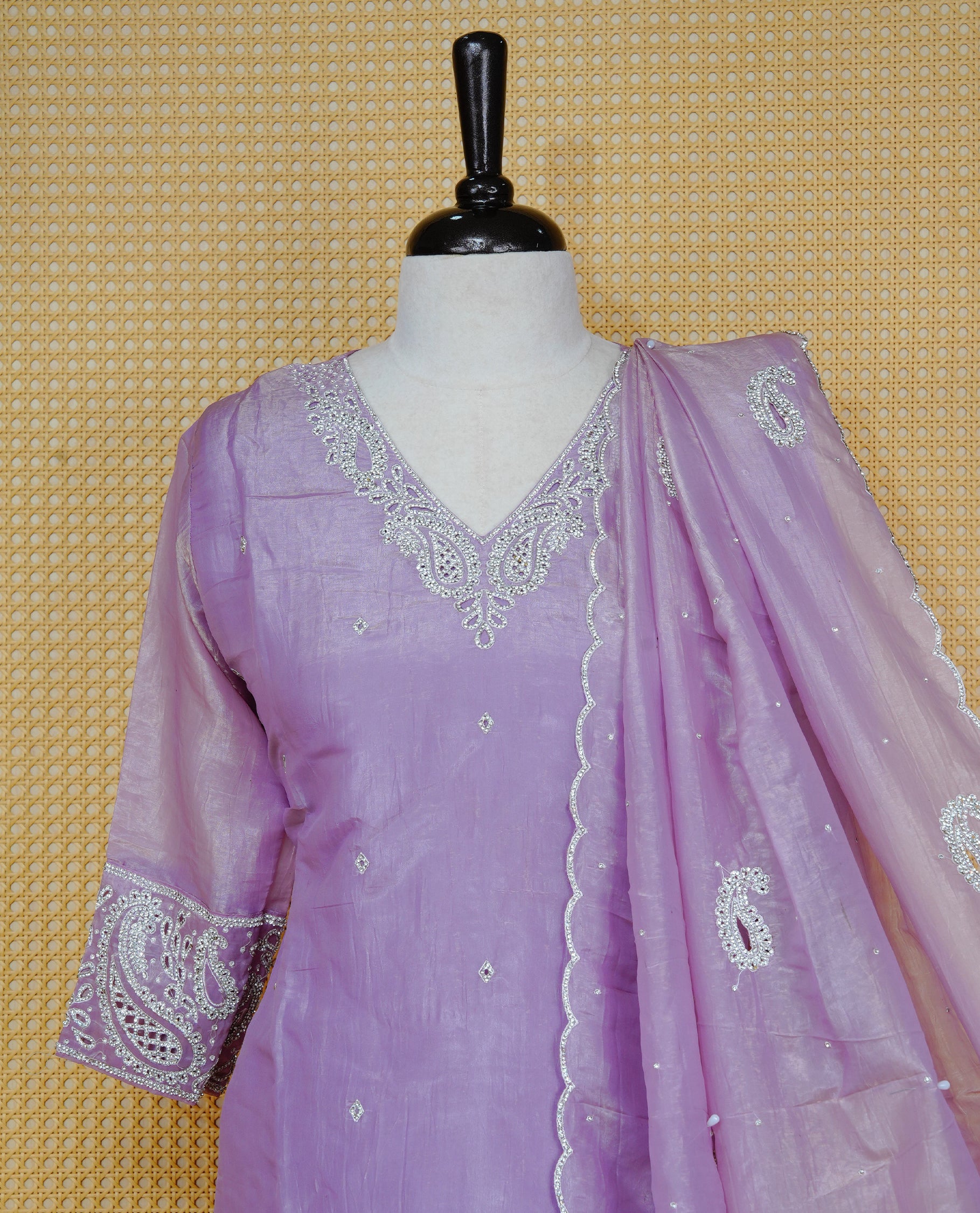 Lavender Colour churidar set with silver-tone thread, bead and sequin embroidery on the V-neckline and sleeve cuffs, subtle buti detailing, a matching embroidered paisley dupatta, and solid pants.