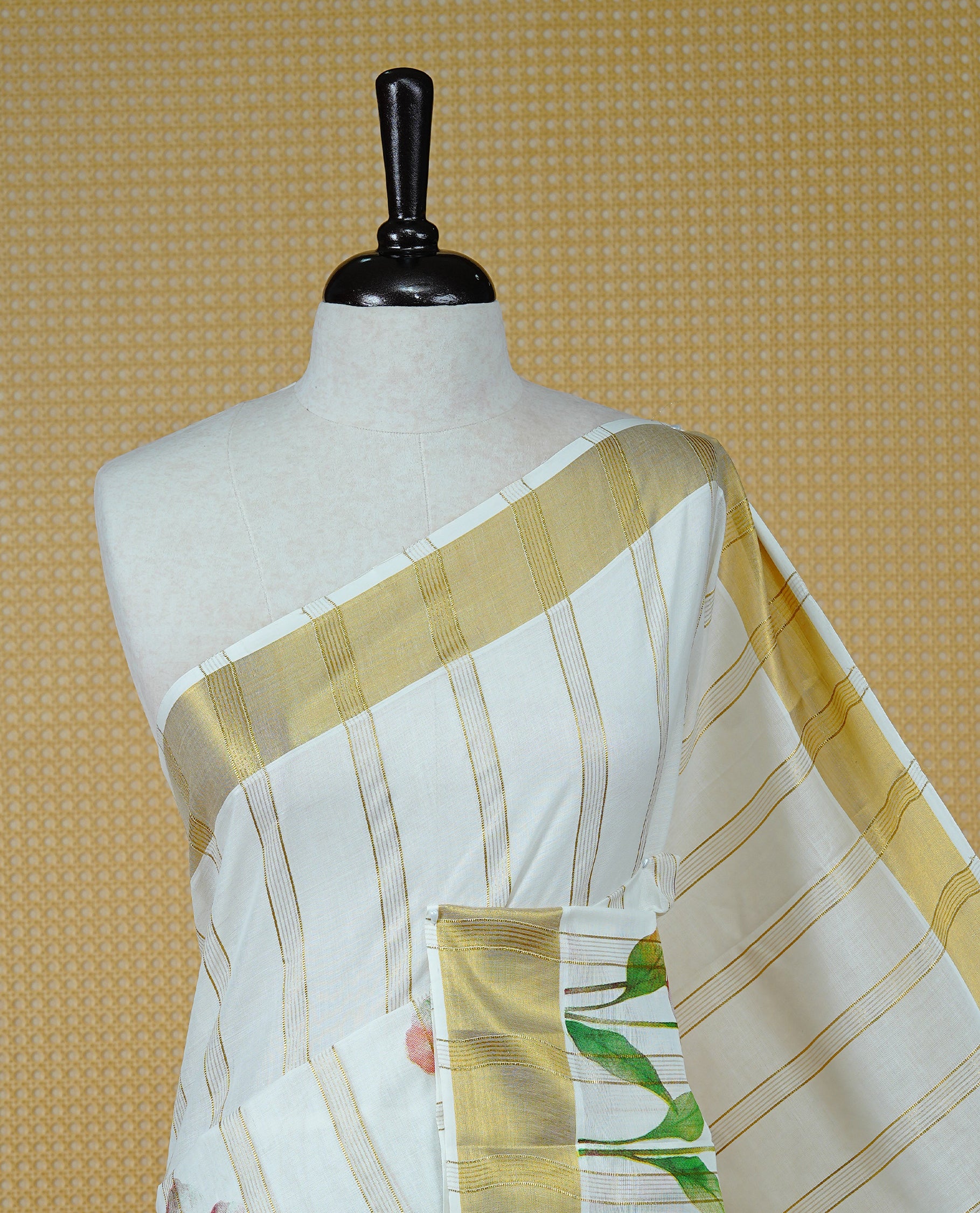 Cream Colour Kerala Saree Featuring Gold Zari Stripes On Body, Enrich Gold Zari With Floral Printed Border & Pallu, Paired With Matching Blouse Piece.