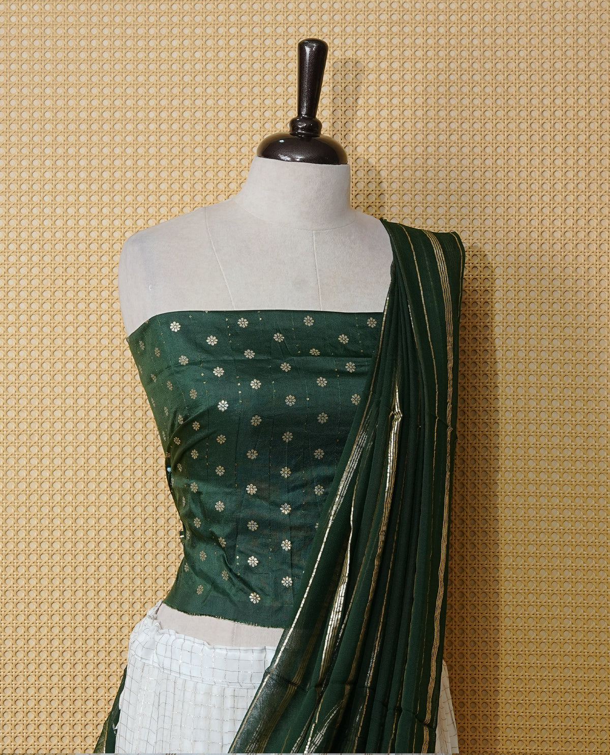 Off white colour Semi stitched dhavani set featuring Gold zari check pattern with contrast Bottle green border skirt, paired with matching blouse & dupatta.