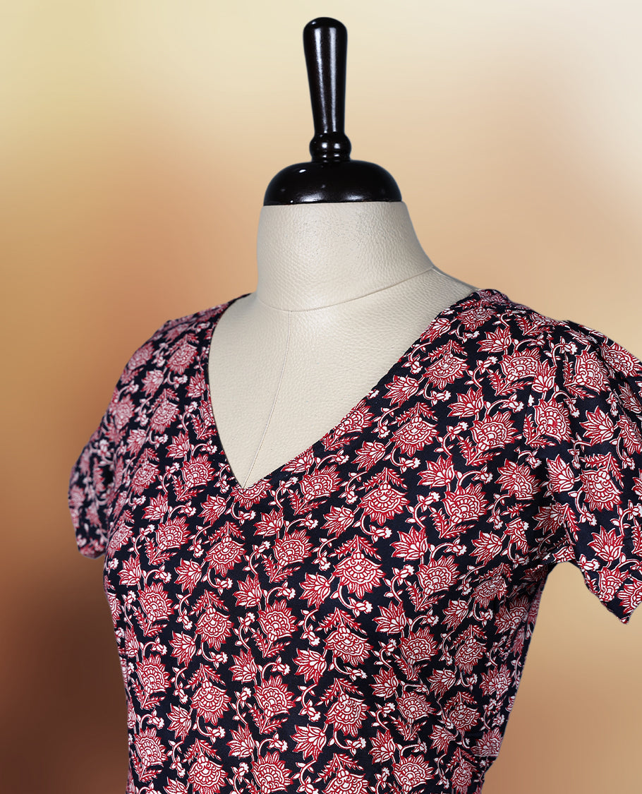 Black colour nightwear adorned with soft pink floral prints, featuring a V neckline, short sleeves, and a flared ruffle hem, A stylish and comfortable choice for daily wear, brunches, or casual outings.