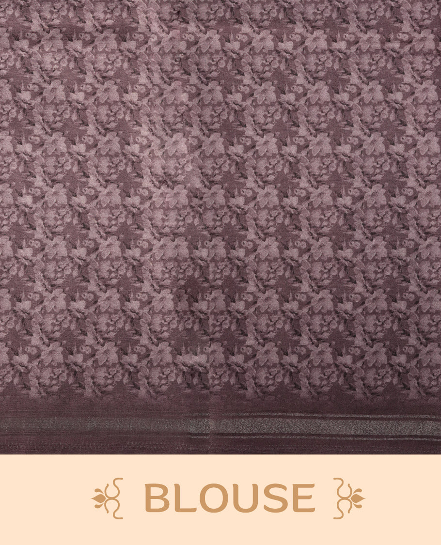 Mauve colour saree adorned with elegant floral prints on the body, enhanced with a subtle matching border, complemented by a beautifully printed pallu featuring blooming flowers, and paired with a matching blouse.