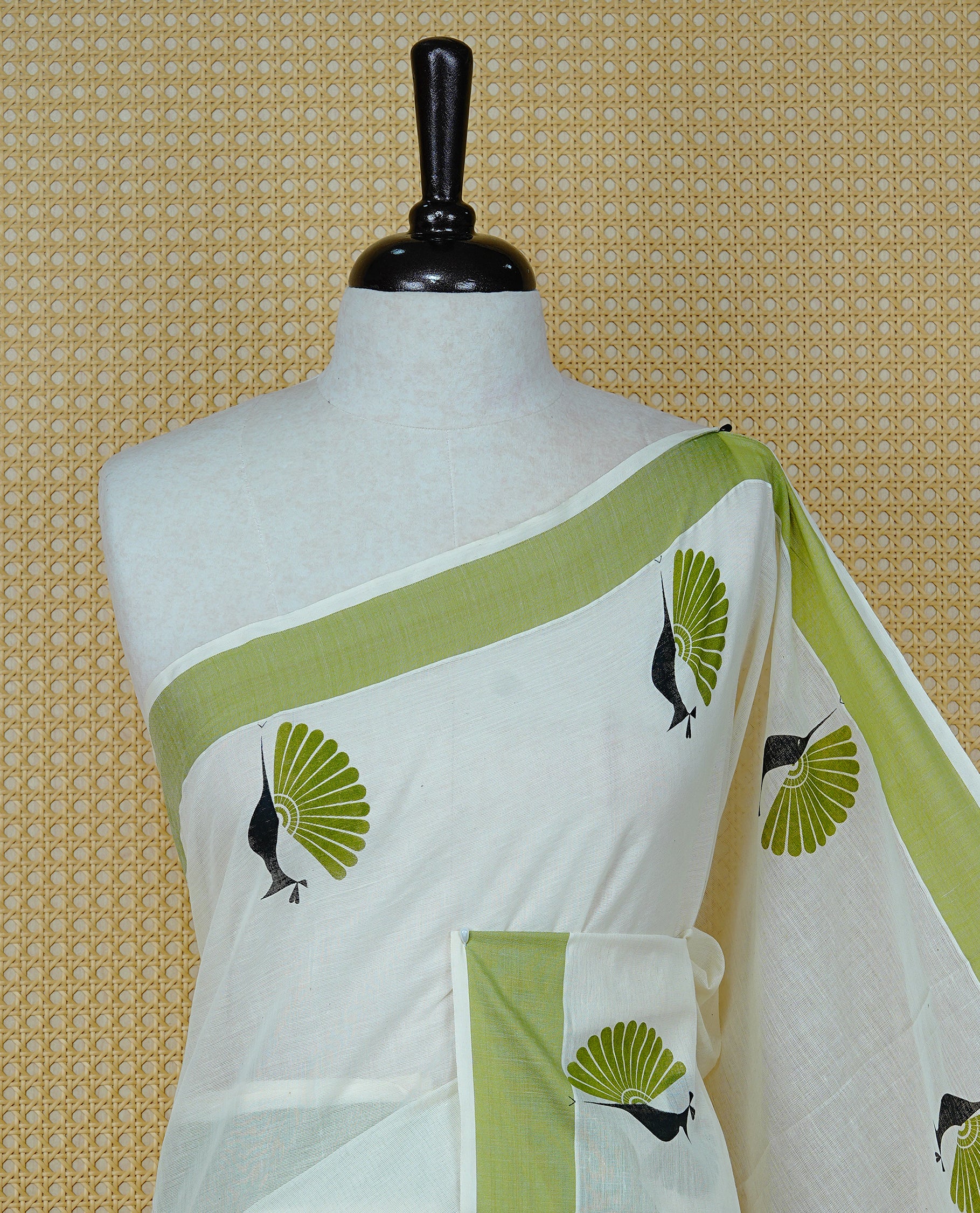 Cream colour Cotton Kerala saree Featuring Classy Plain body for Effortless Elegance, enhancing Green with Peacock Printed border, paired with matching blouse piece.