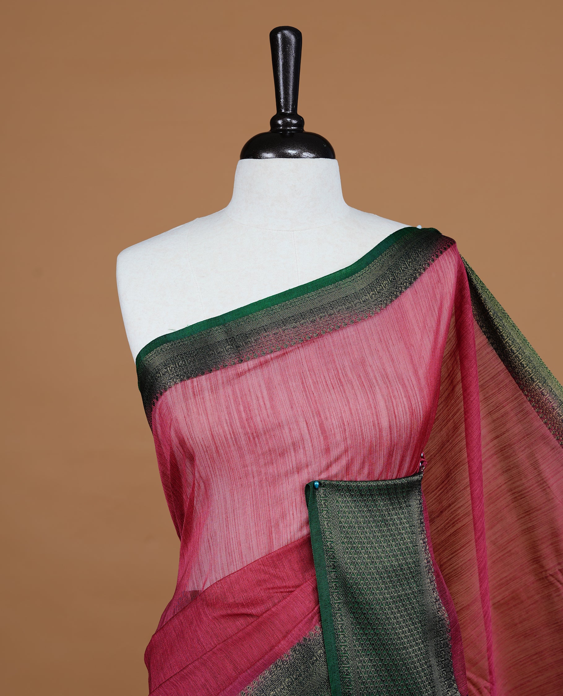 Mauve colour Semi linen saree featuring Elegant plain body, complemented by contrast Green colour With Antique zari border, paired with matching blouse piece.