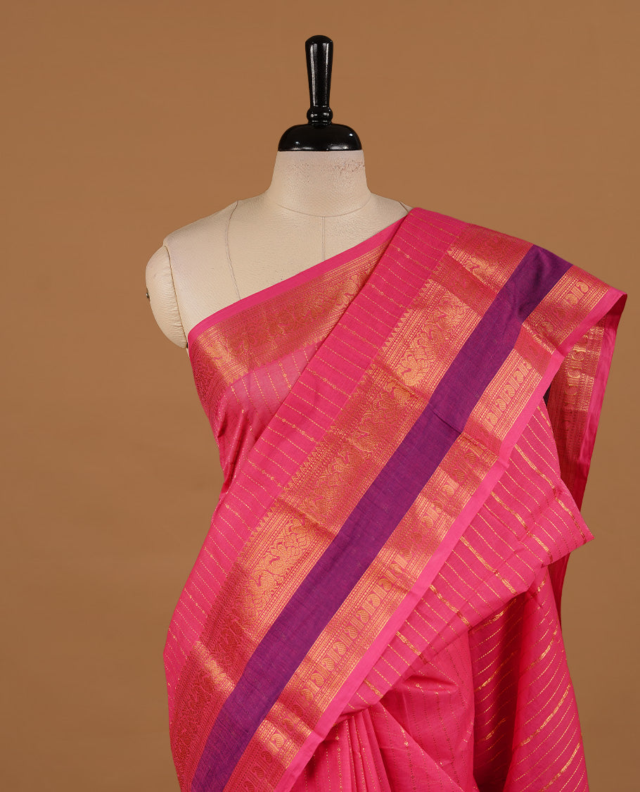 Magenta colour chettinad cotton saree featuring gold zari stripes on body, complemented by purple colour with zari border, paired with matching blouse piece.