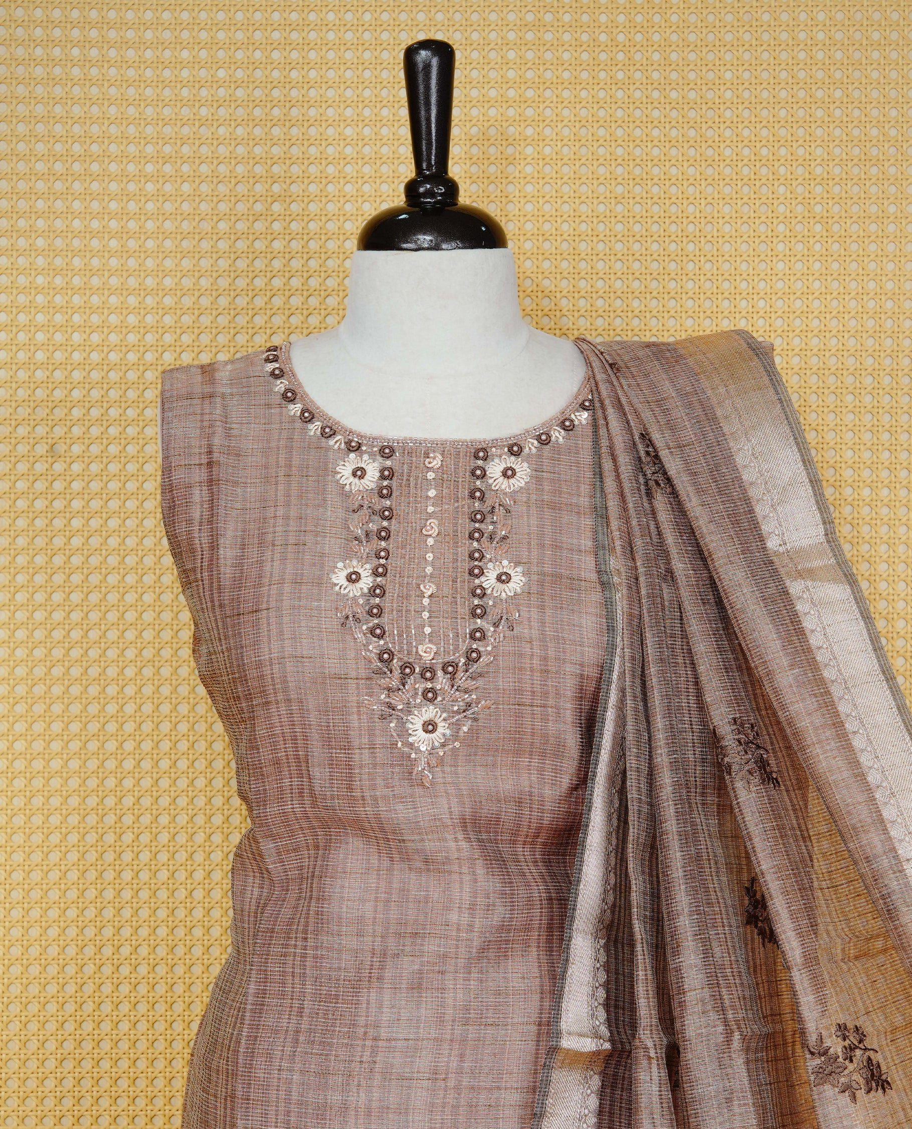 Brown colour Tissue Churidar Set featuring delicate floral embroidery and subtle sequin detailing on the yoke, paired with matching solid pants and dupatta.