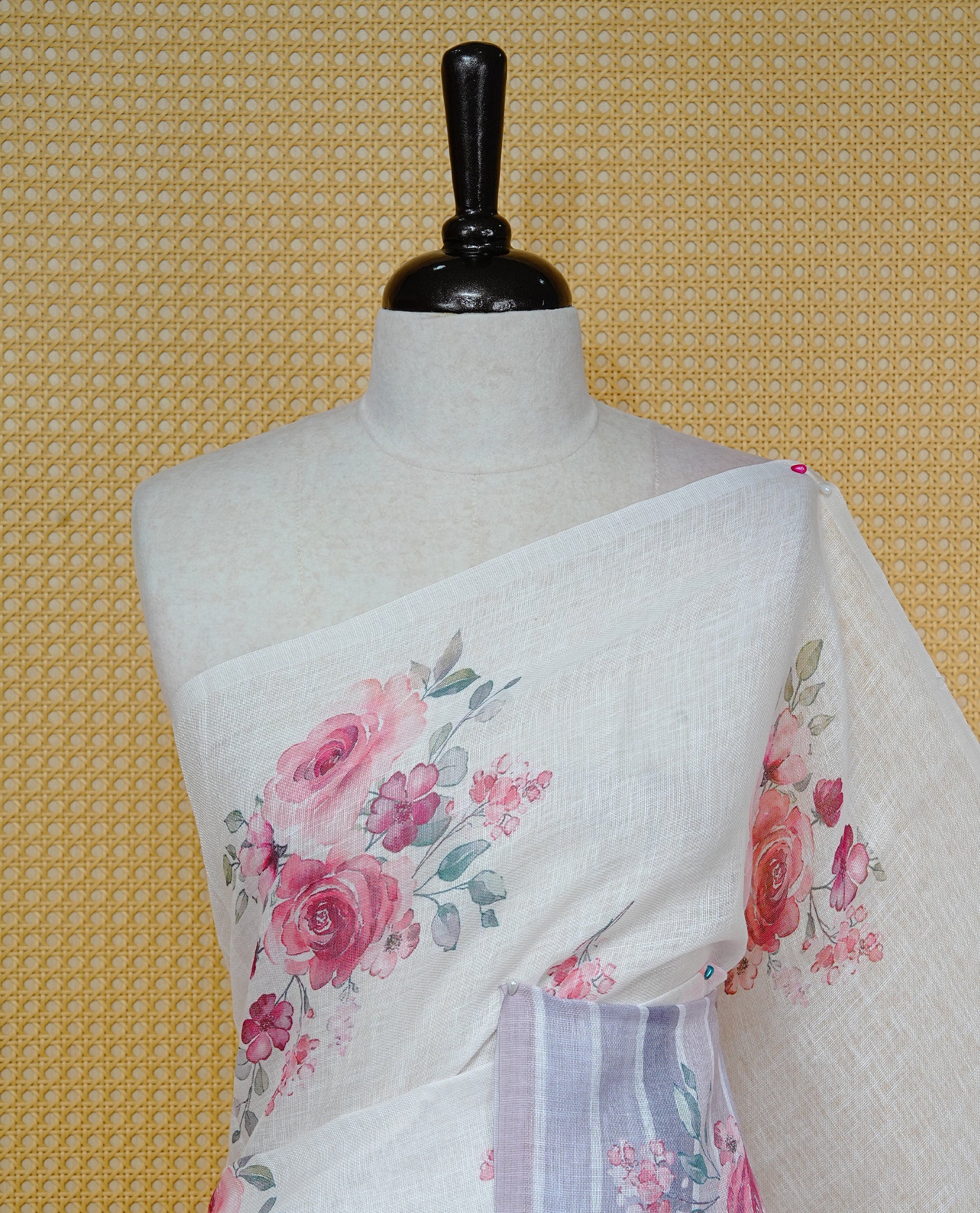 Cream colour semi linen saree featuring Red colour floral print on body, complemented by contrast Strip pattern border, comes with matching blouse piece.