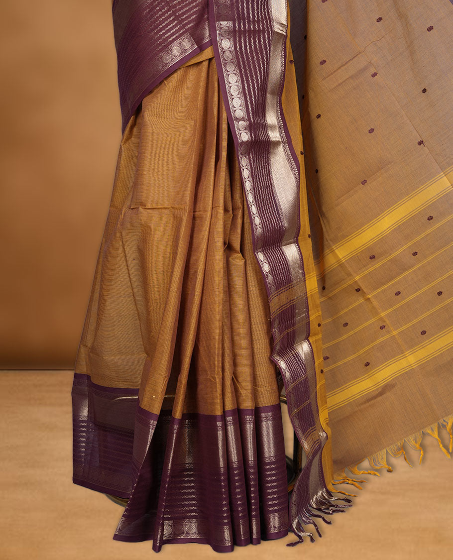 Mustard colour chettinad cotton saree featuring maroon colour motifs on body, contrast maroon colour border with gold zari border, pallu and paired with matching blouse