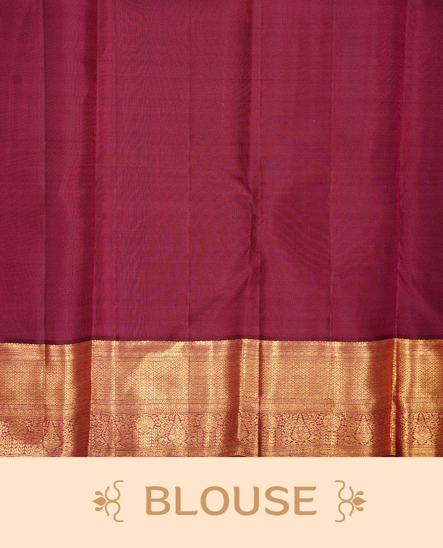 Burgundy colour kancheepuram silk saree featuring gold zari pattern across body, complemented by selfcolour border traditional zari border, paired with matching blouse piece.