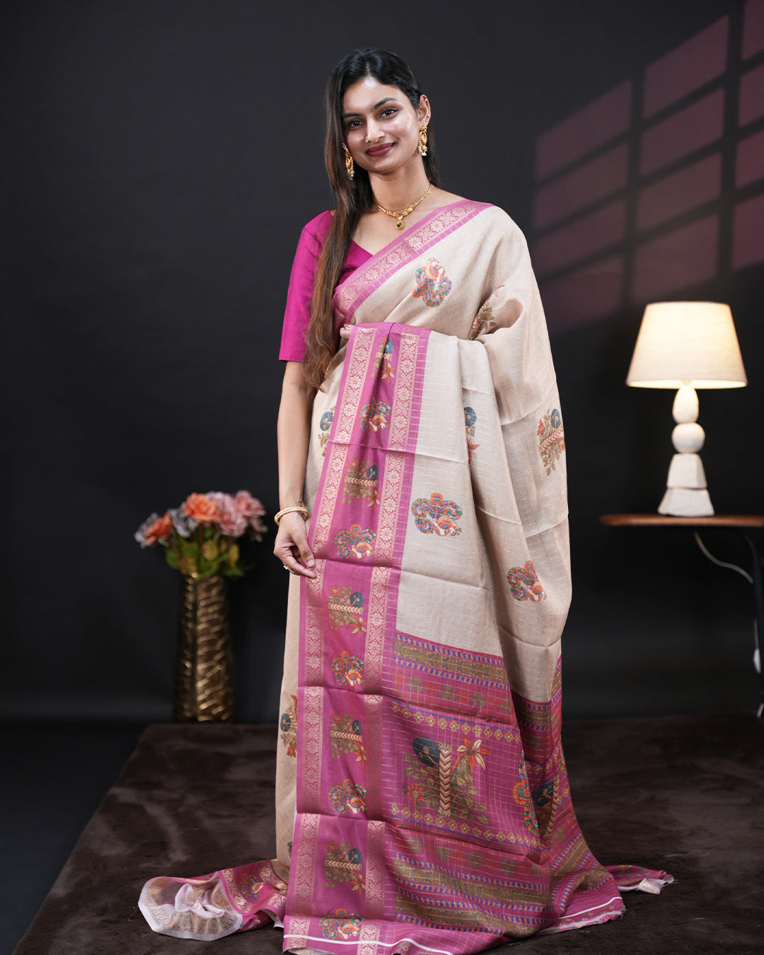 Cream Colour Moss chiffon saree featuring Peacock & Floral prints on the body, Pink Colour double border with Floral prints and a contrast designed pallu, paired with a contrast designed blouse piece.