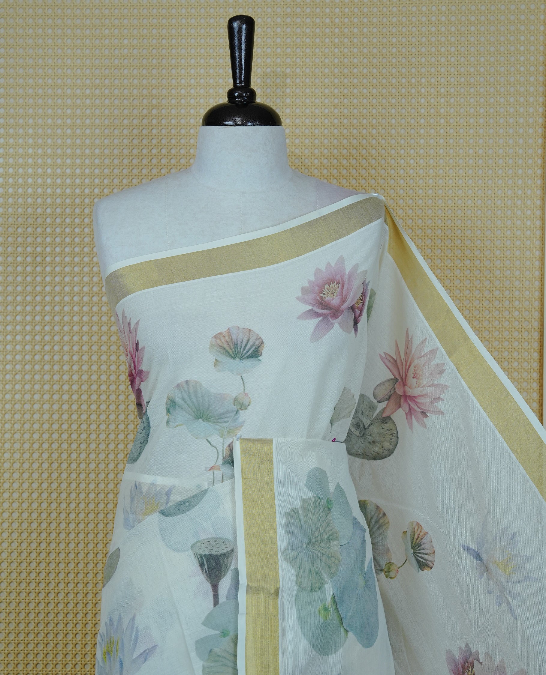 Cream colour Cotton kerala Saree featuring Lotus Print on body, Enhancing Gold zari kasavu border, comes with matching blouse piece.