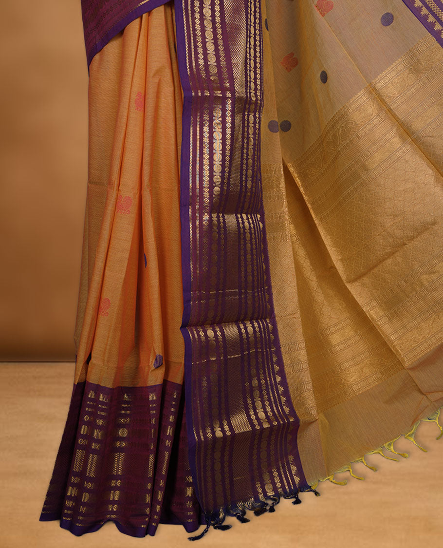 Dusty orange colour chettinad cotton saree featuring Purple colour motifs on body, contrast purple colour border with gold zari border, pallu and paired with matching blouse.