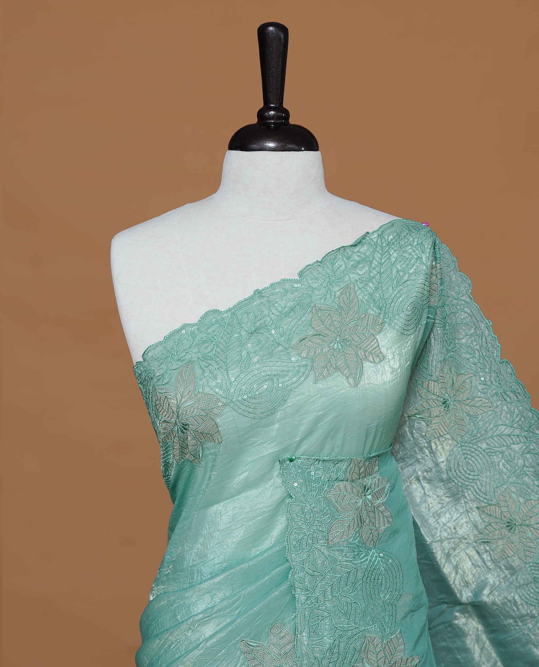 Pastel Green colour Crush Organza Featuring Plain body, Enrich with Floral thread pattern with sequins & scalp border, paired with matching blouse piece.