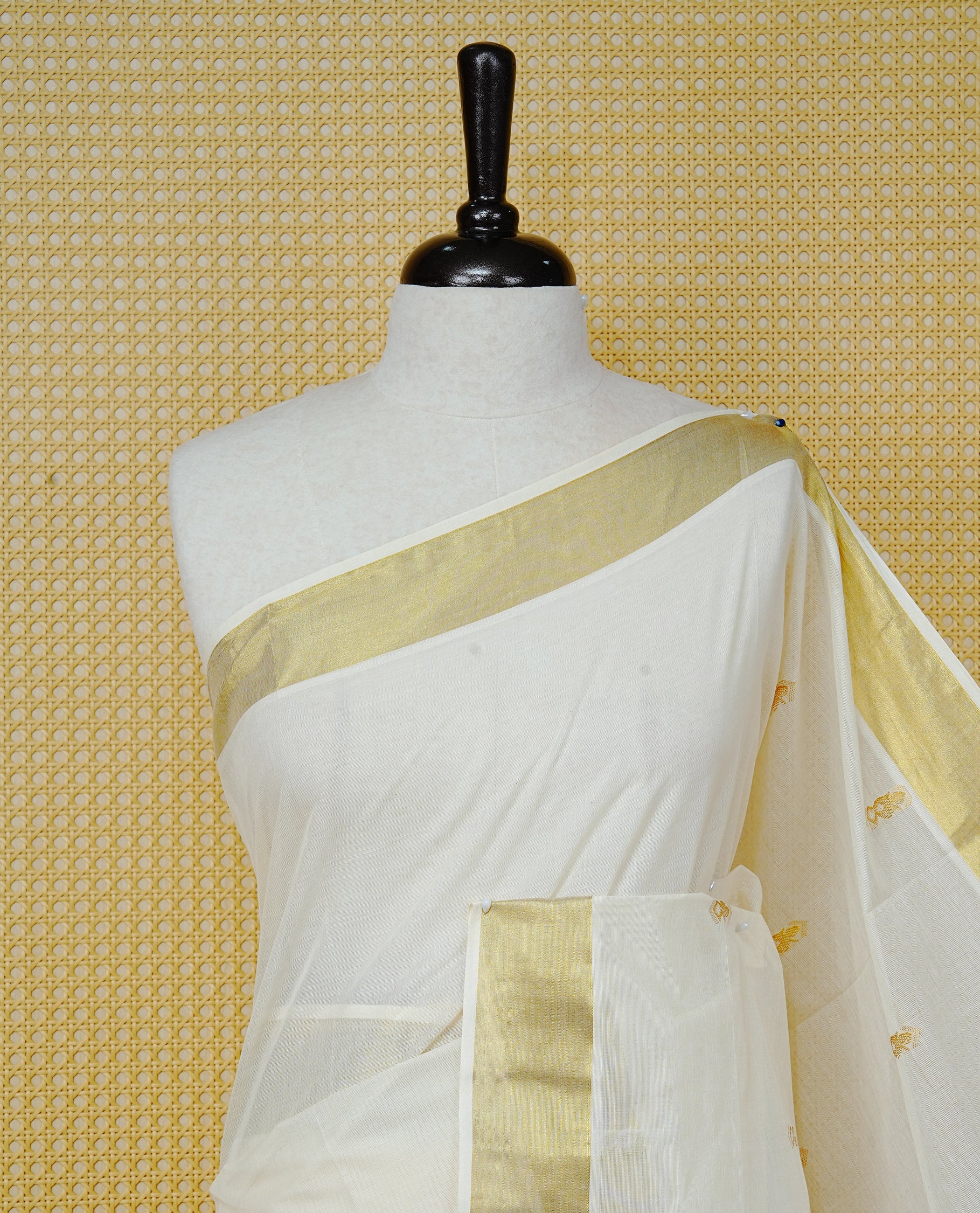 Cream Colour Cotton Kerala Saree Featuring Delicate Gold Zari Leaf Pattern Across The Body, Enhanced With A Traditional Gold Zari Border , A Gold Leaf Motifs Striped Gold Zari Pallu, Finished With A Matching Blouse Piece