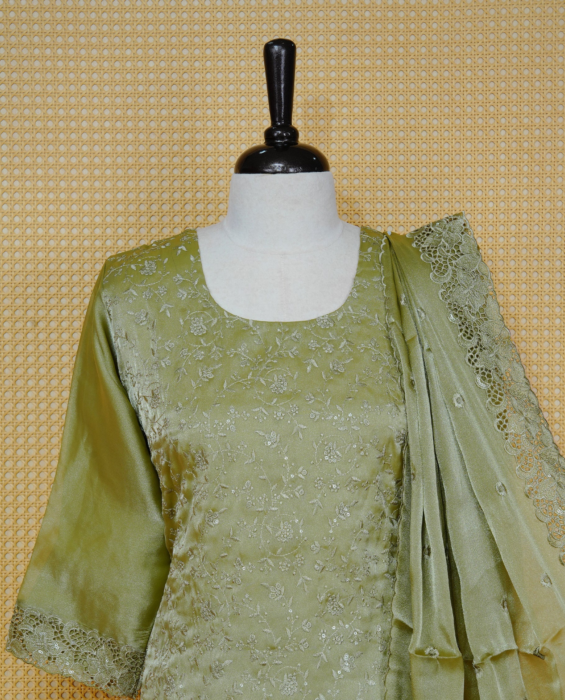 Olive green Colour churidar set with floral thread embroidery On body & U shaped Neckline, paired with a matching lace-bordered dupatta and solid pants.