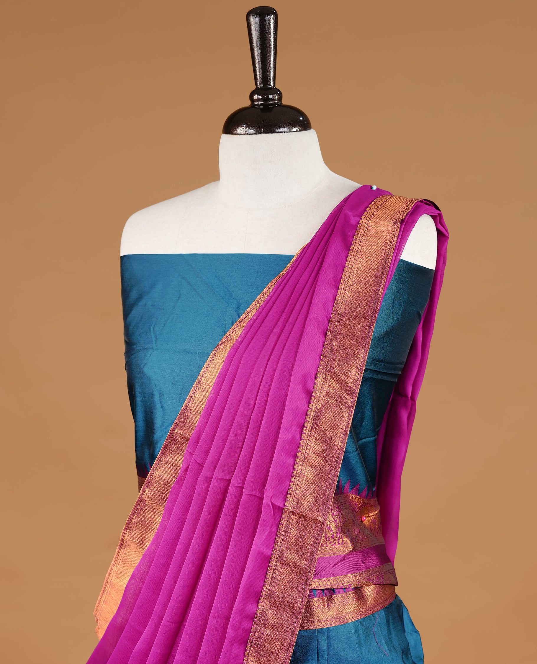 Teal colour semi stitched Half saree featuring contrast Magenta colour with gold zari traditional border skirt, paired with matching zari border dupatta, unstitched blouse piece