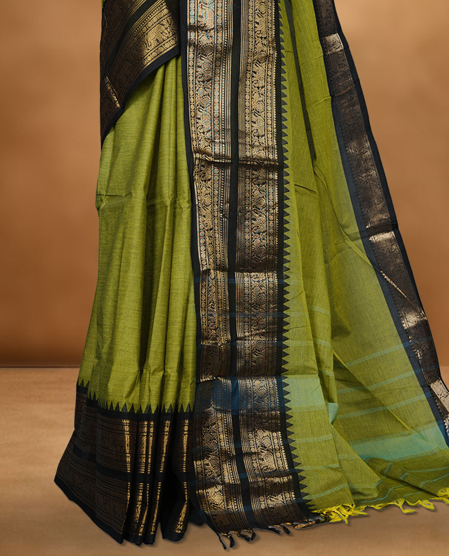 Lemon green colour chettinad cotton saree featuring plain body, contrast black colour with traditional gold zari border without blouse.