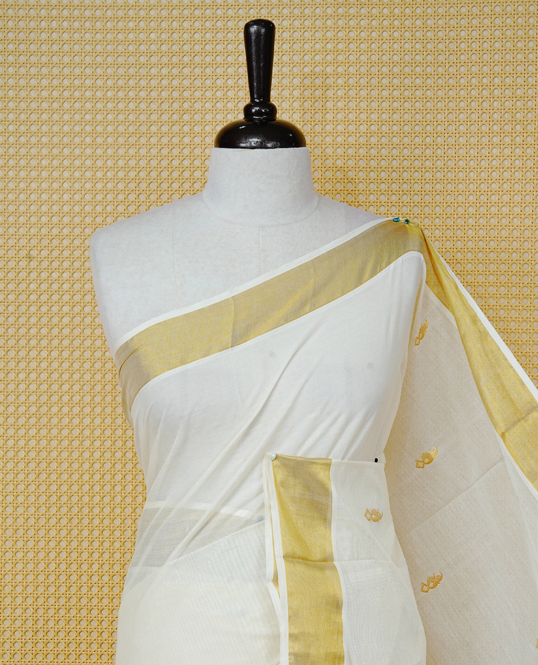 Cream Colour Cotton Kerala Saree Featuring a Classic Gold Zari Border and Delicate Gold Leafs Motifs Across the Pallu. Finished with Fine Gold Stripes for a Timeless Traditional Look, Paired with a Matching Blouse Piece.