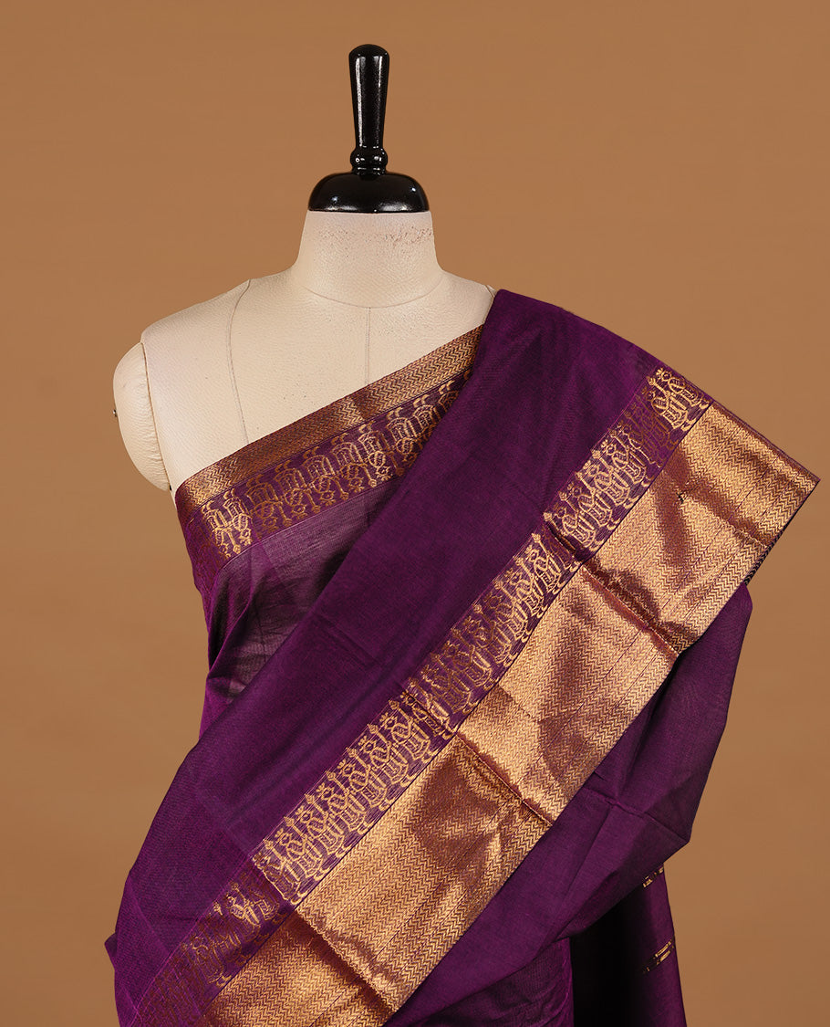 Deep purple colour chettinad cotton saree featuring elegant plain body, complemented by self colour with zari border, paired with matching blouse piece.