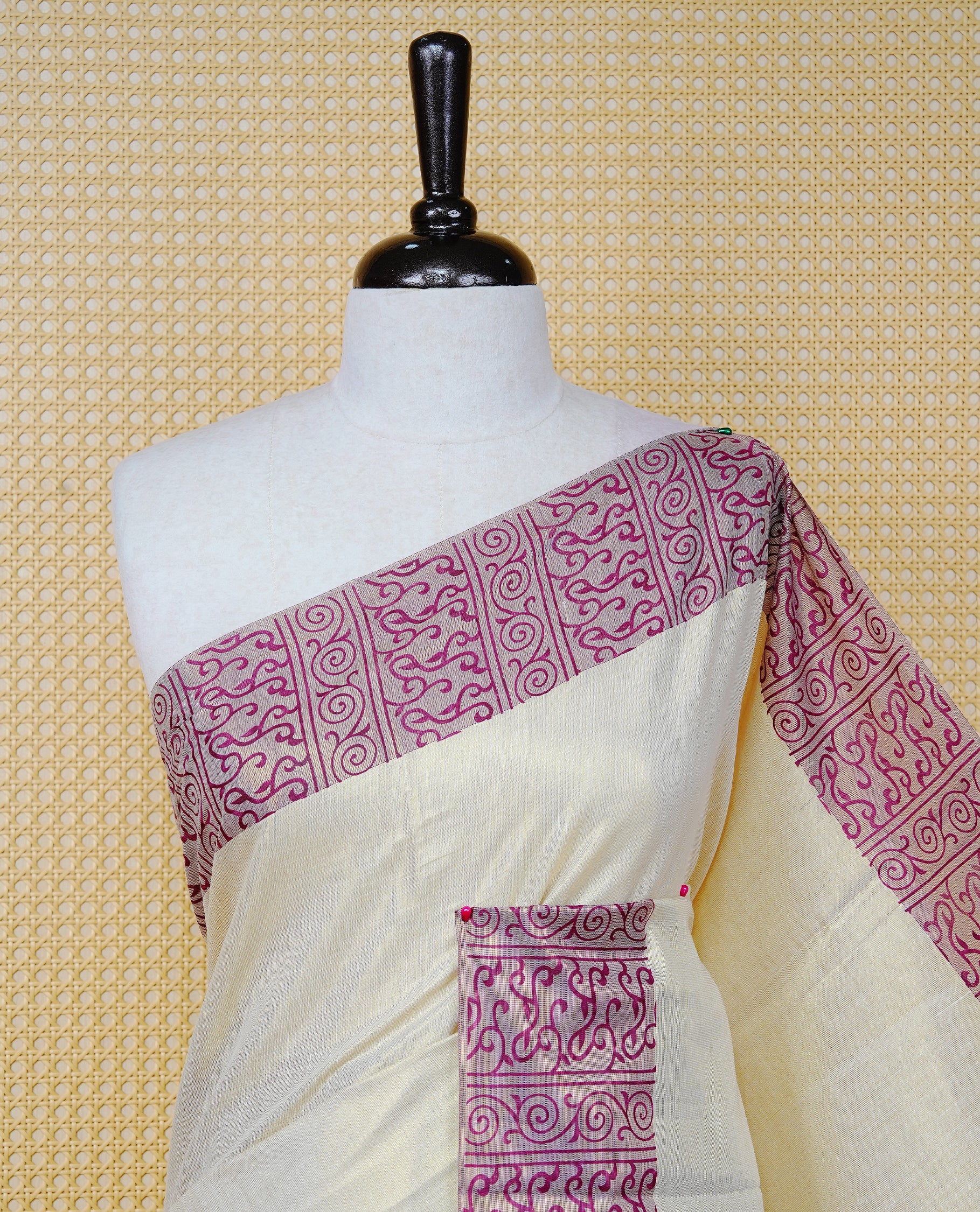 Cream Colour Tissue Kerala Saree Featuring a Plain Body, Enhanced with Violet Block Printed Borders, a Violet and Gold Zari Pallu, Violet Tassels, and a Matching Blouse Piece.