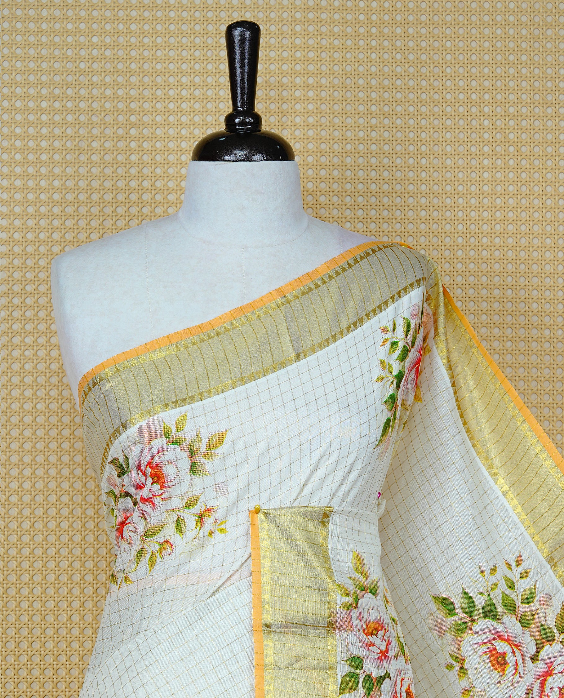 Cream Colour Kerala Saree Featuring Gold Zari Checks On The Body, Enhanced By A Gold Zari Border With Floral Prints And A Matching Pallu, Paired With A Matching Blouse Piece.