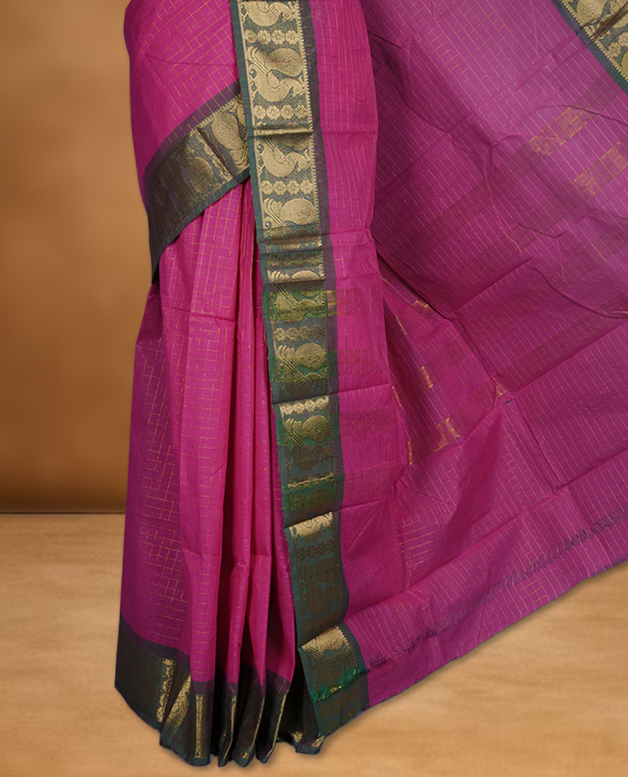 Magenta colour sungudi cotton saree featuring gold zari check pattern across body, contrast green colour with gold zari peacock and floral pattern on border, without blouse piece.