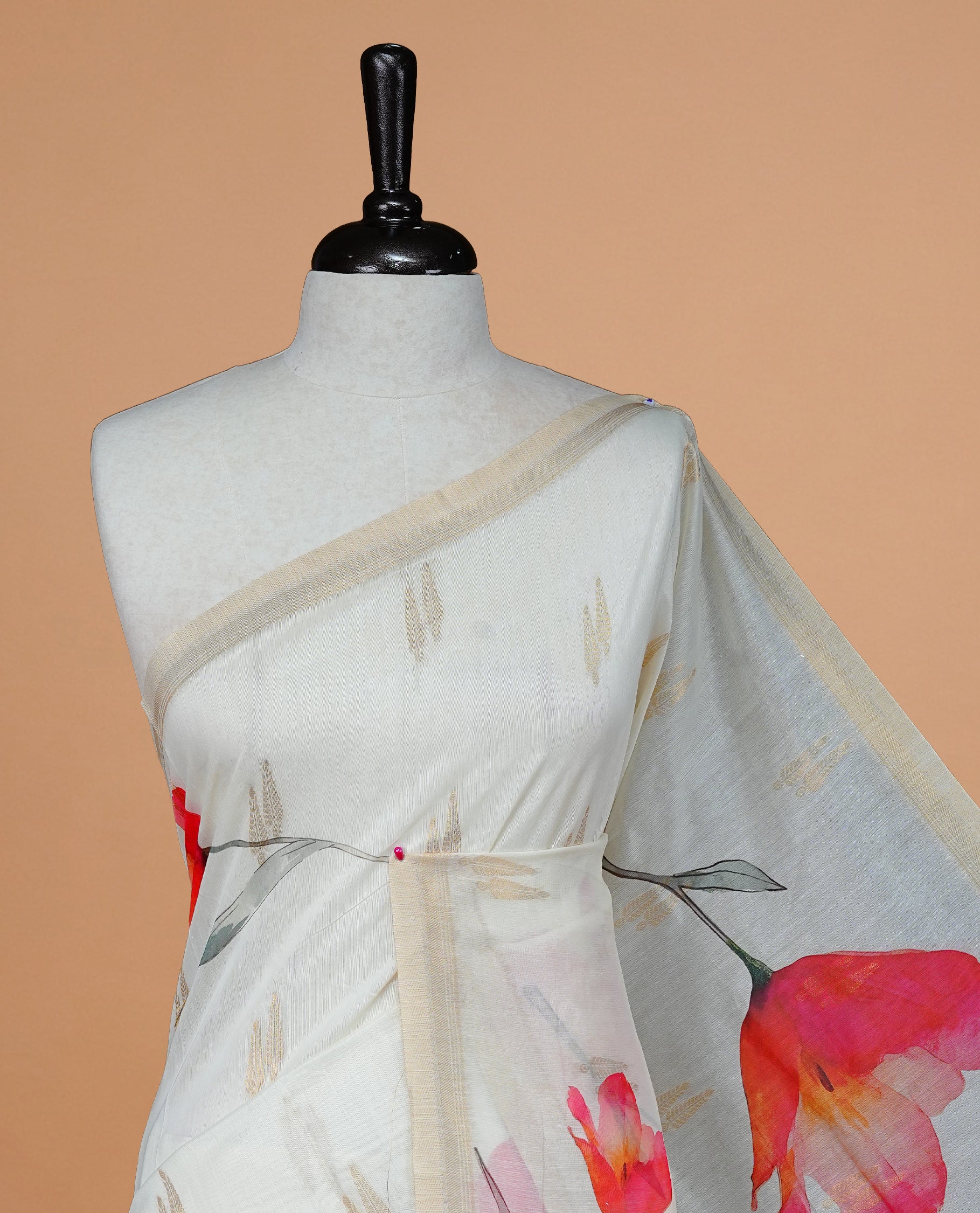 Cream Colour Organza Kerala Saree Featuring Red Floral Print On The Body, Tassels On The Pallu With A Matching Blouse Piece.