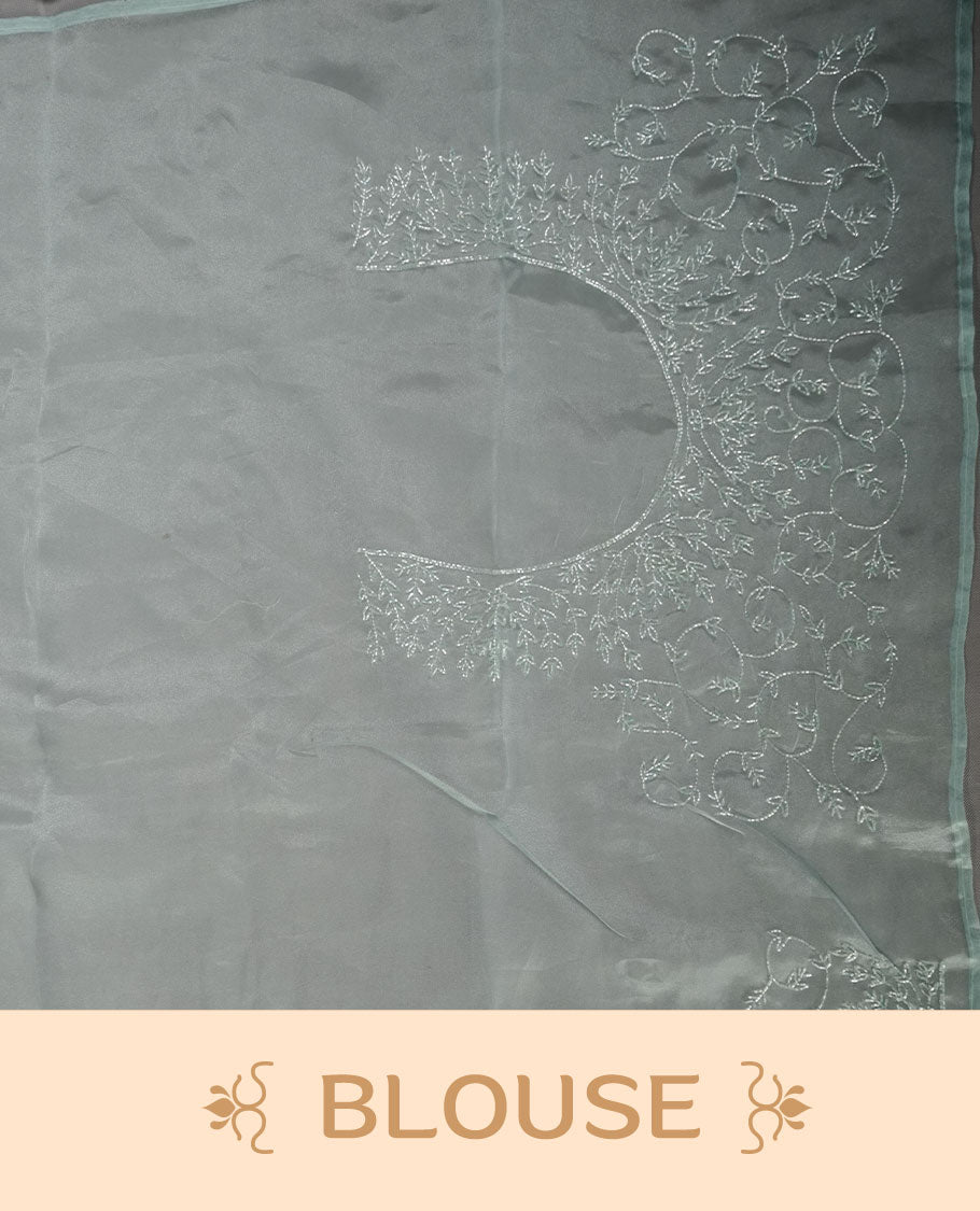 Mint blue colour Organza designer saree featuring a thread geometric pattern across the body, enhanced with a piping border and cut beats work on matching blouse piece.