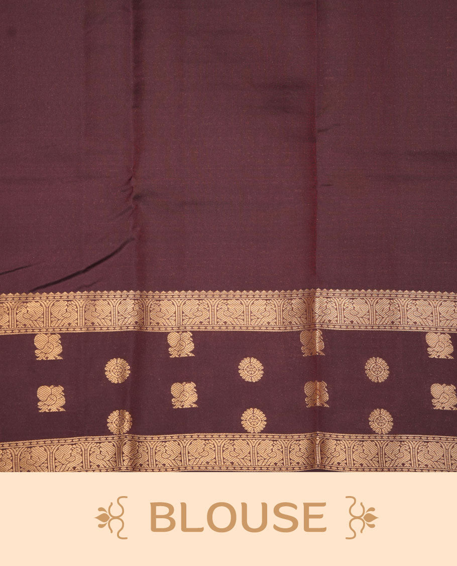 Brick red colour Vasundhara silk saree featuring zari motifs on body, complemented by contrast coffee brown colour with zari buttas border, paired with matching.