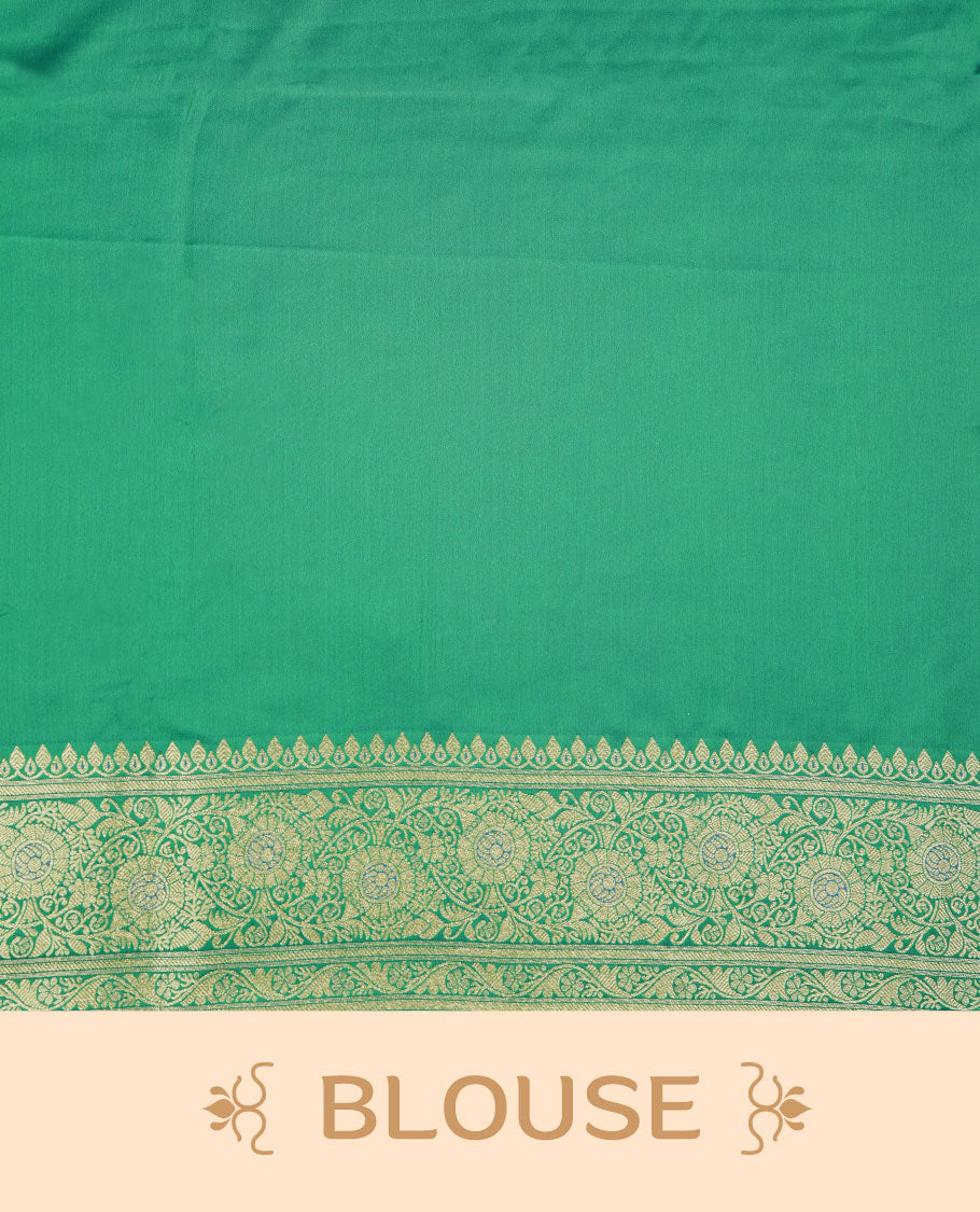 Emerald green colour Banaras Satin Crepe saree featuring gold zari floral motifs on the body, a richly woven traditional border with intricate gold zari detailing, and paired with a matching blouse.