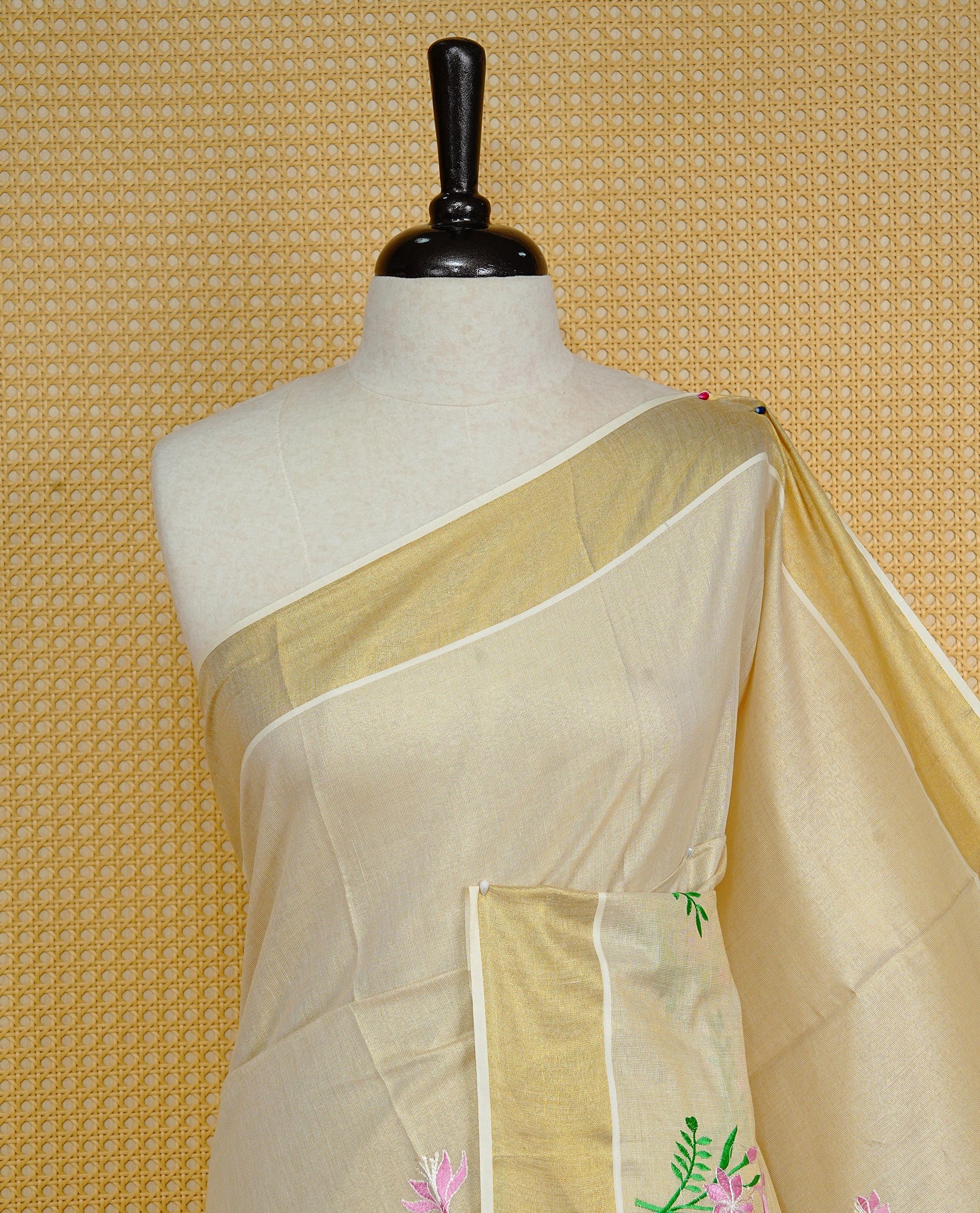 Cream colour Tissue kerala saree featuring Embroidery buttas on body, complemented by Floral plant thread work & kasavu kara, comes with matching blouse piece.
