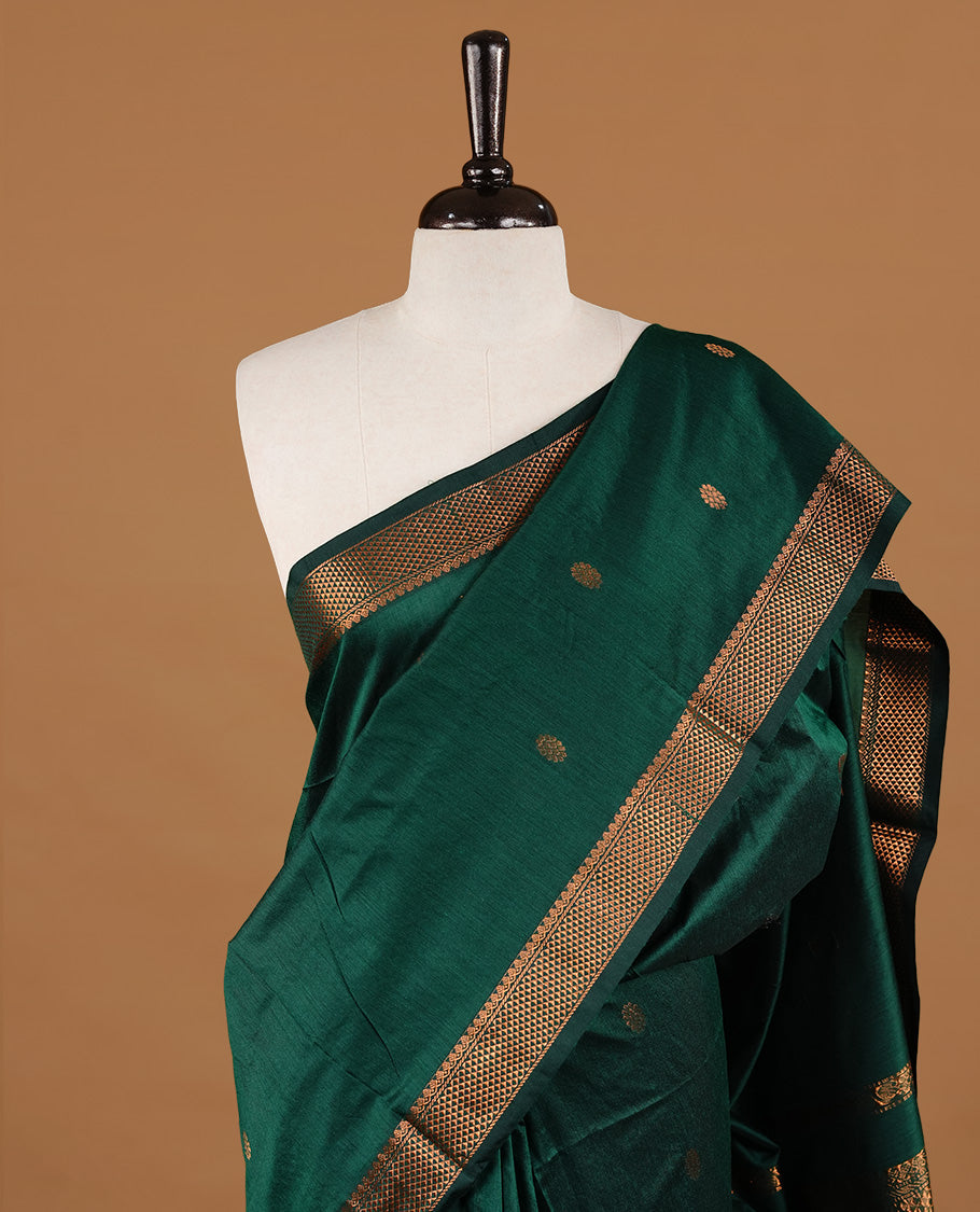 Green colour kalyani cotton saree featuring gold zari motifs on body, highlighting self colour with Antique gold zari border, paired with matching blouse piece.