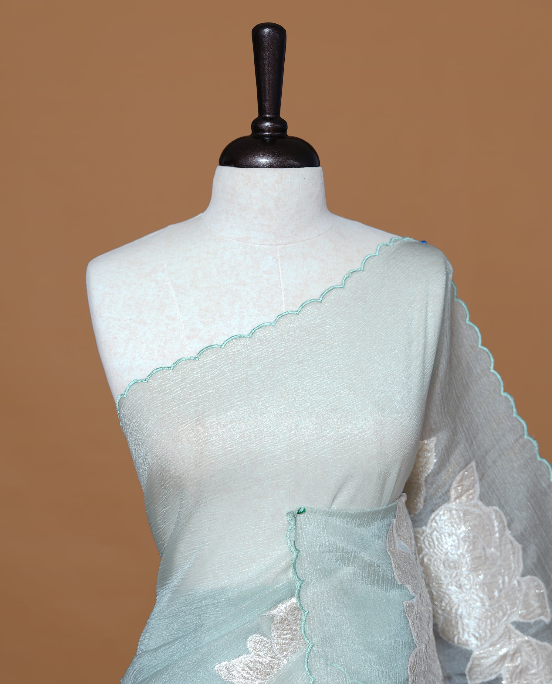 Pastel Green colour Crush Organza Saree featuring White floral Pattern on body, complemented by classy Thread border, paired with matching blouse piece.