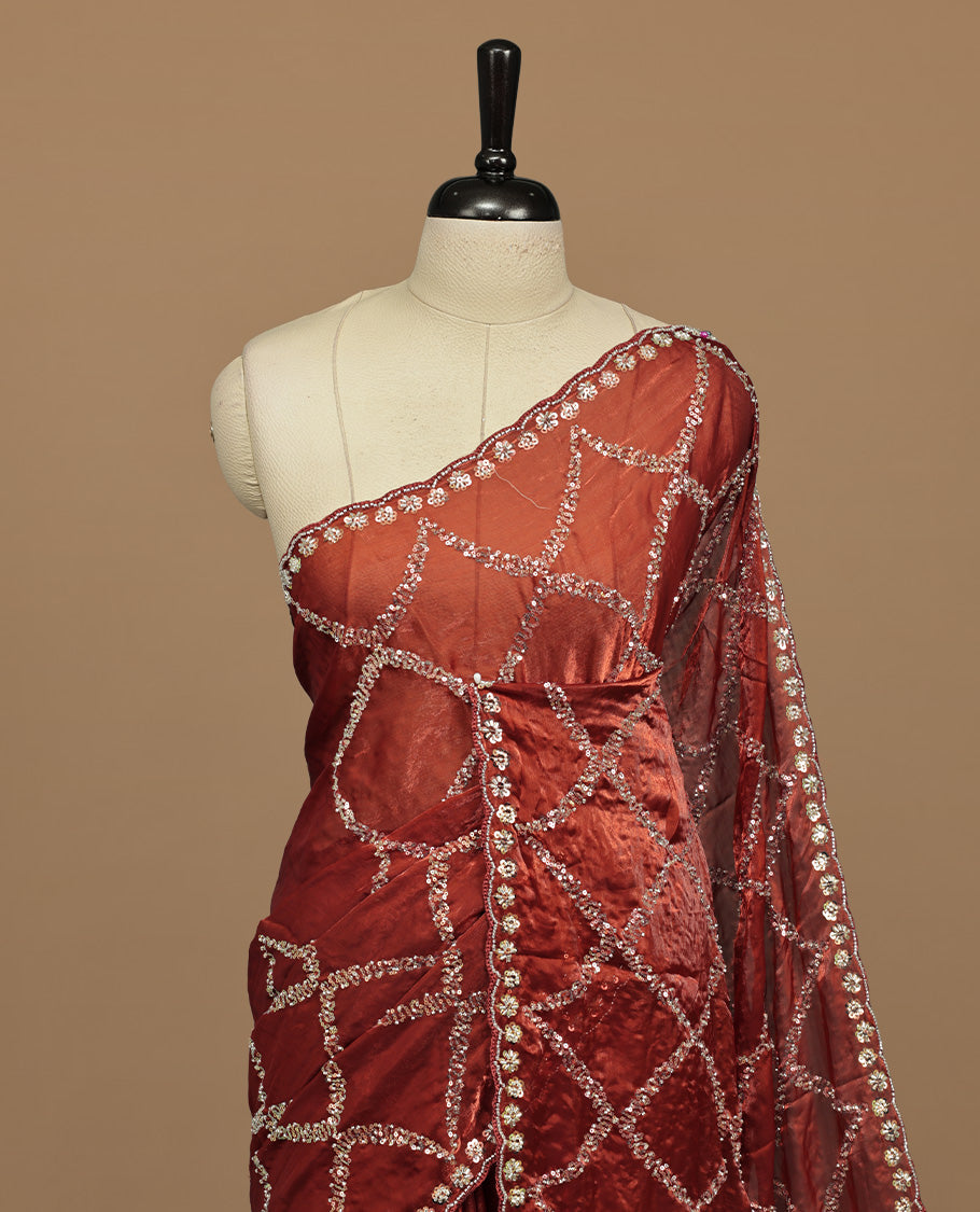 Brownish Orange colour designer saree featuring Sequins & cut beats worked body, cut beat worked border, paired with matching unstitched blouse.