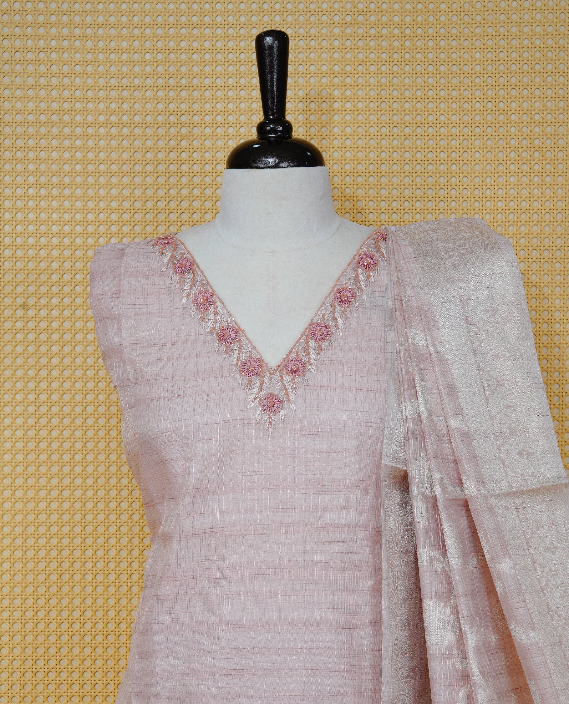 Blush pink colour churidar set with floral bead and thread embroidery on the V-neckline, paired with a matching woven dupatta and solid pants.