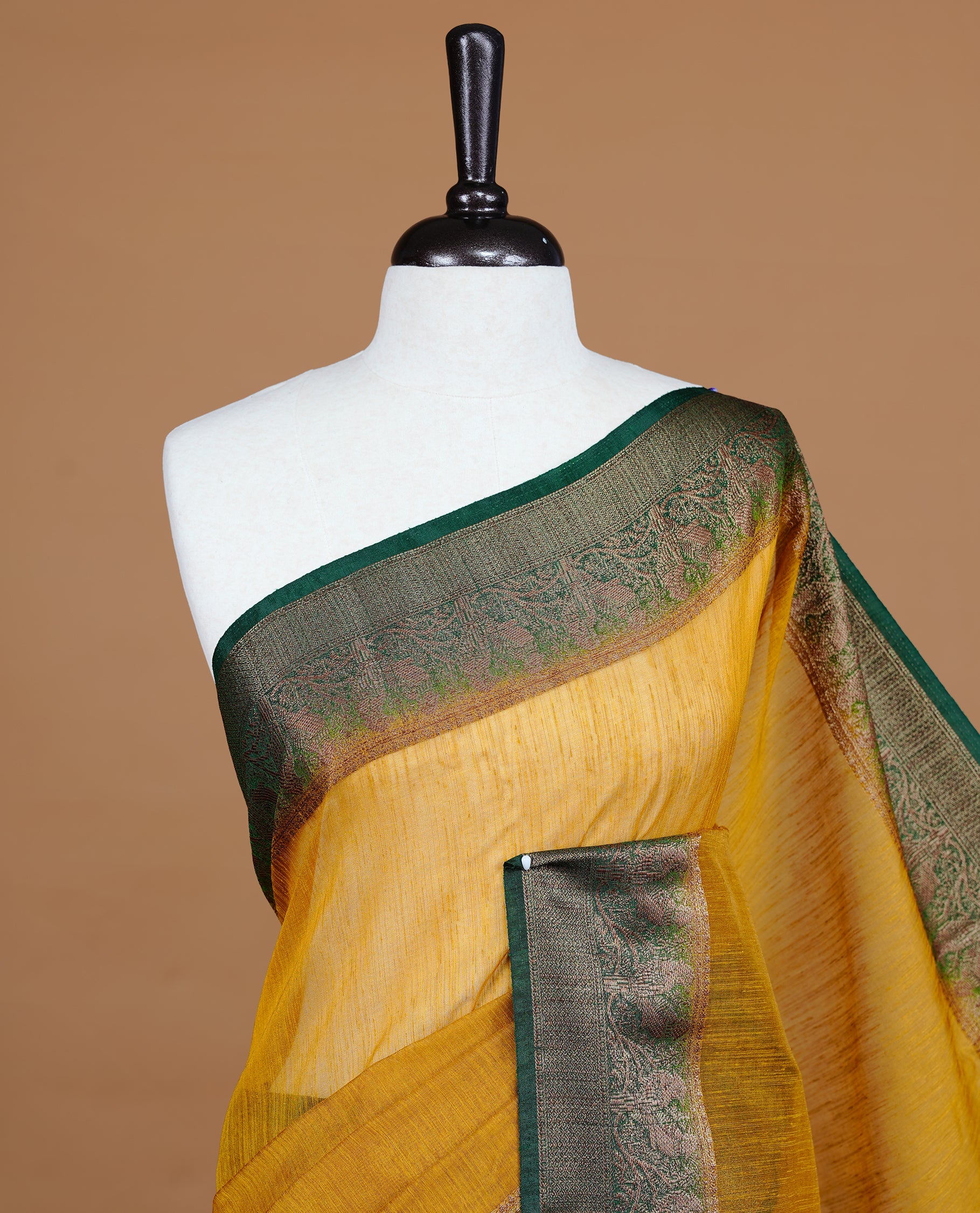Yellow colour Semi linen saree featuring Elegant plain body, complemented by contrast Green colour With Antique zari border, paired with matching blouse piece.
