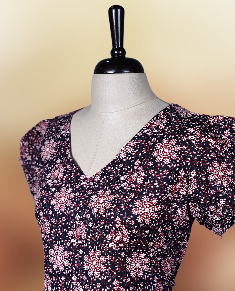 Black colour printed nightwear with soft floral patterns, V neckline, and puff sleeves, The flared hem adds a graceful touch, making it ideal for daily wear, casual outings, or comfy lounge days.